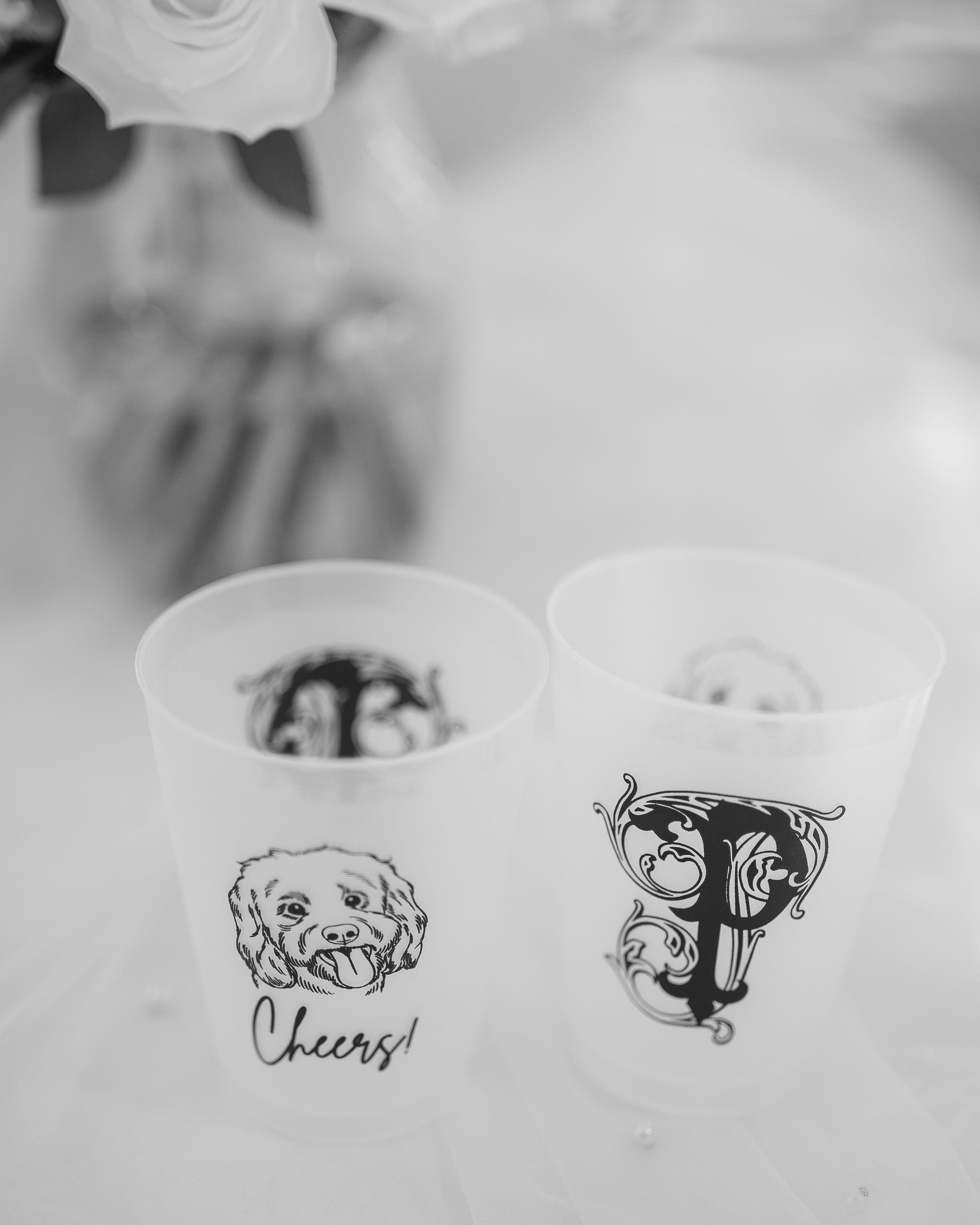 Translucent reusable cups featuring a charming animal illustration and an intricate initial design, perfect for personalized celebratory occasions.