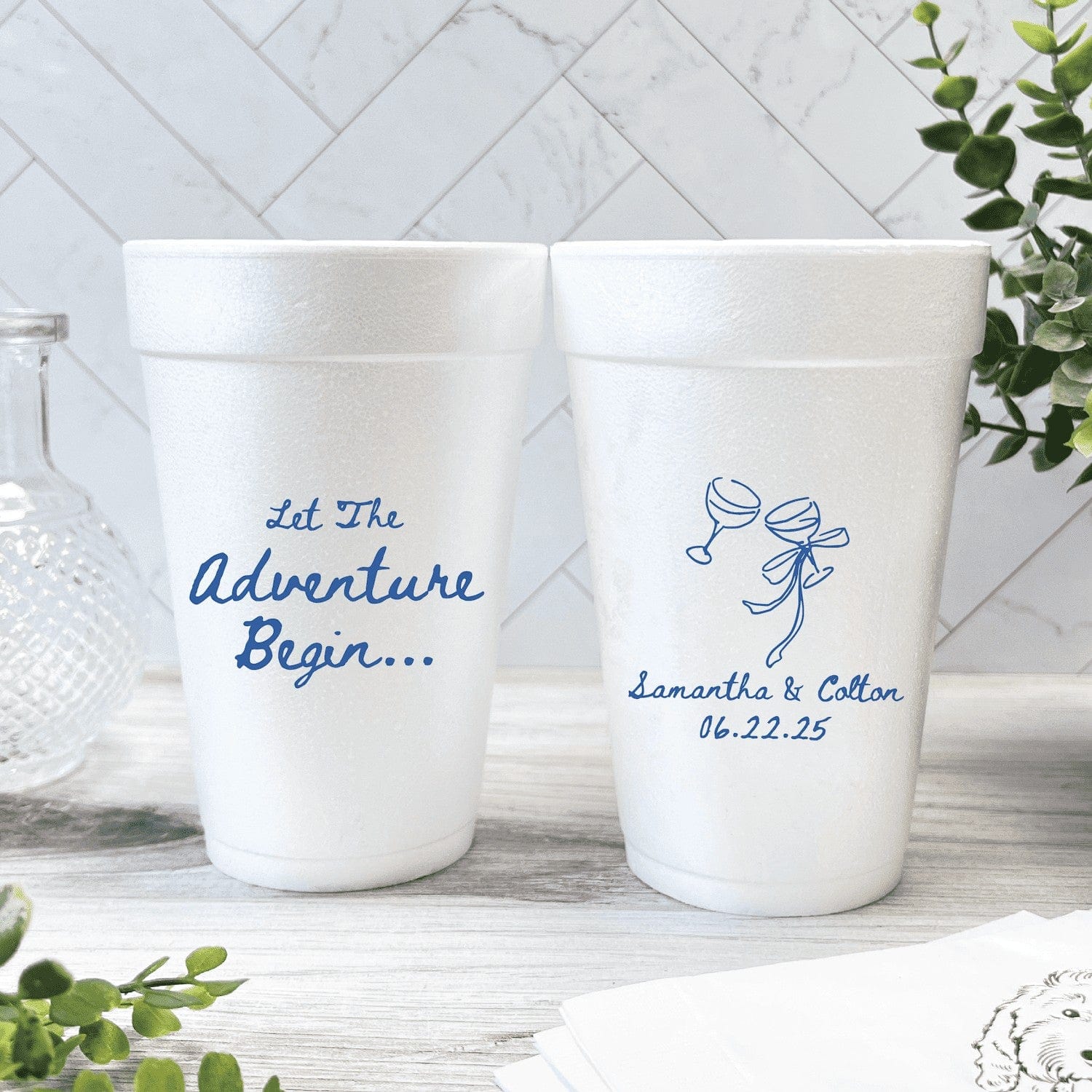Personalized white styrofoam cups with elegant script font designs, custom made for a wedding celebration.