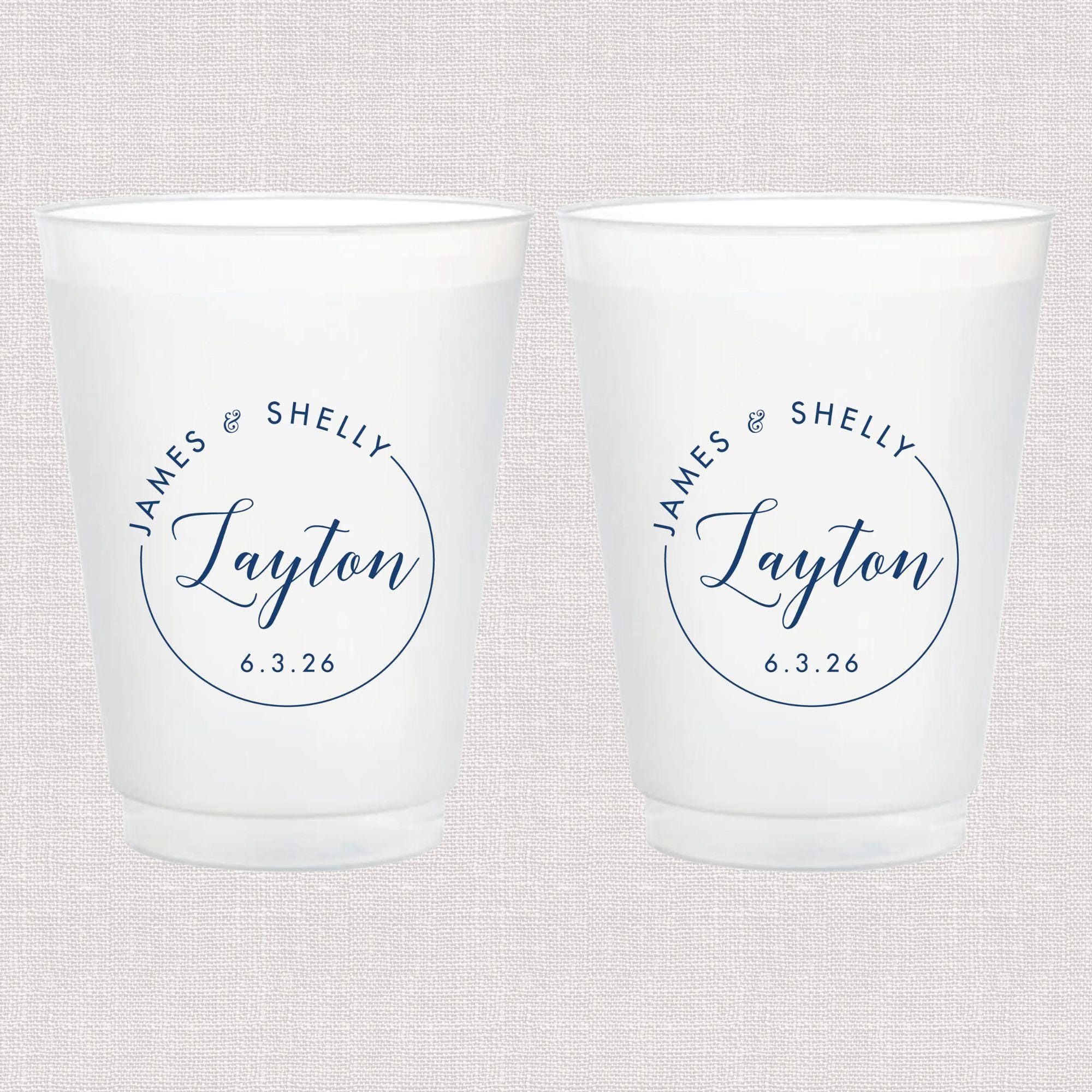 Pair of frosted white cups with navy blue circular monogram design reading "James & Shelly Taylor 6.3.26"