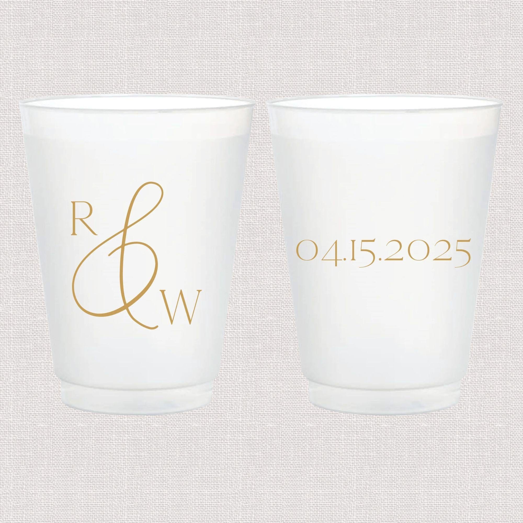 Frosted cups with gold monogram initials R and W on front and wedding date 04.15.2025 on back