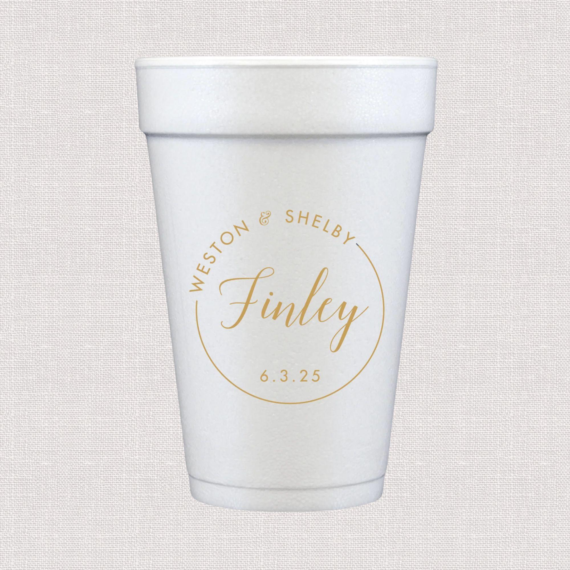 White foam cup with gold personalized circular monogram design and wedding date