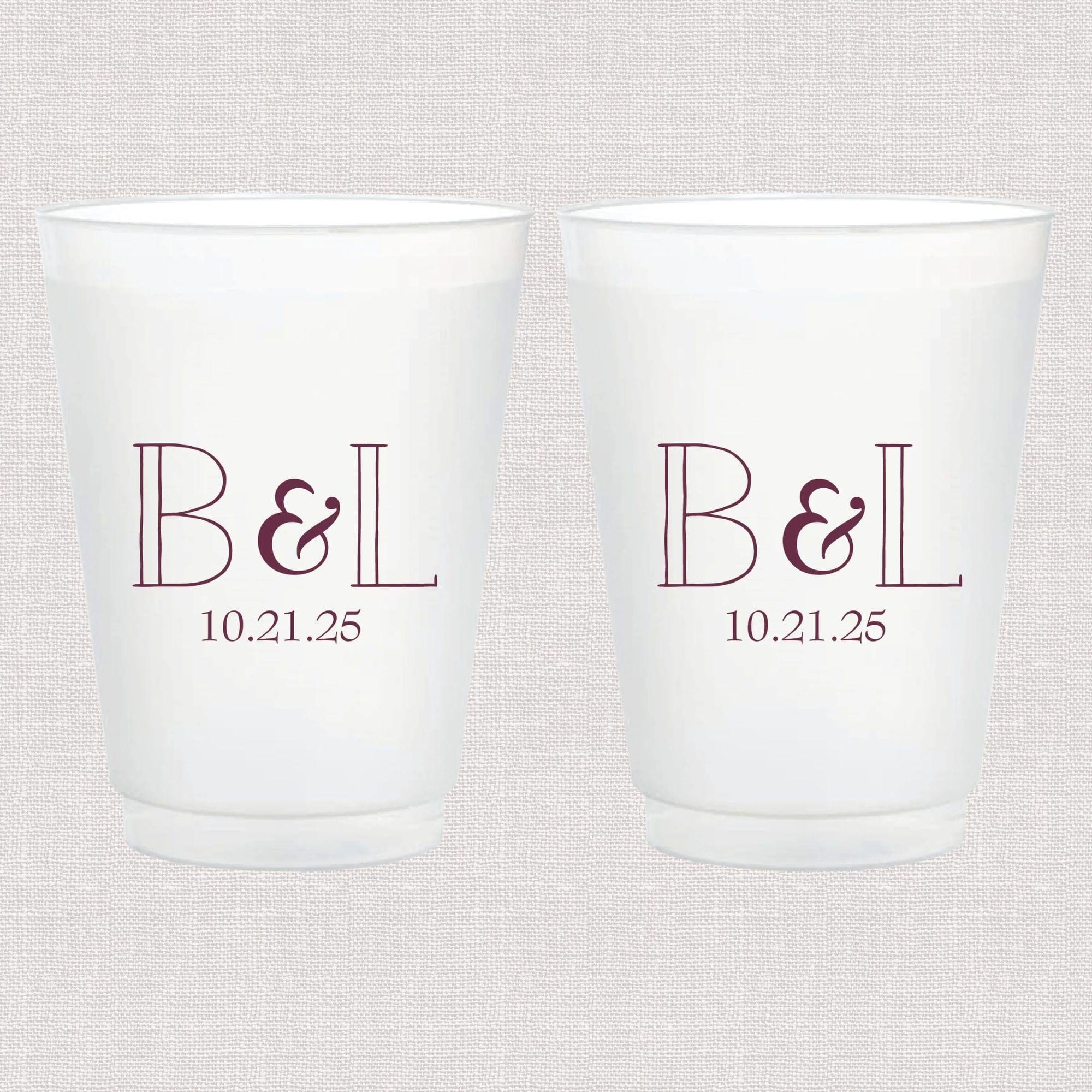 Two frosted white cups with burgundy monogram B&L and date 10.21.25 printed on front