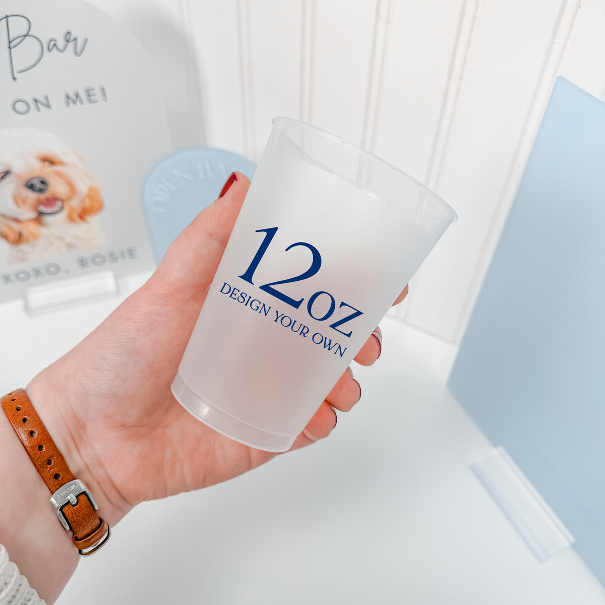 12 oz frosted shatterproof cup held in hand, custom navy design for wedding bar carts