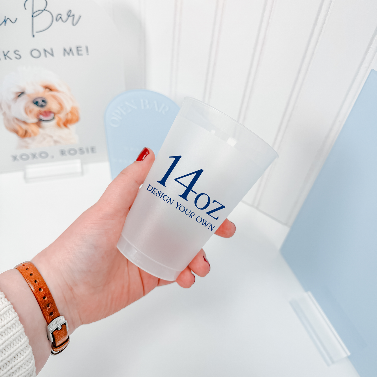 14 oz frosted shatterproof cup held in hand with a personalized navy design
