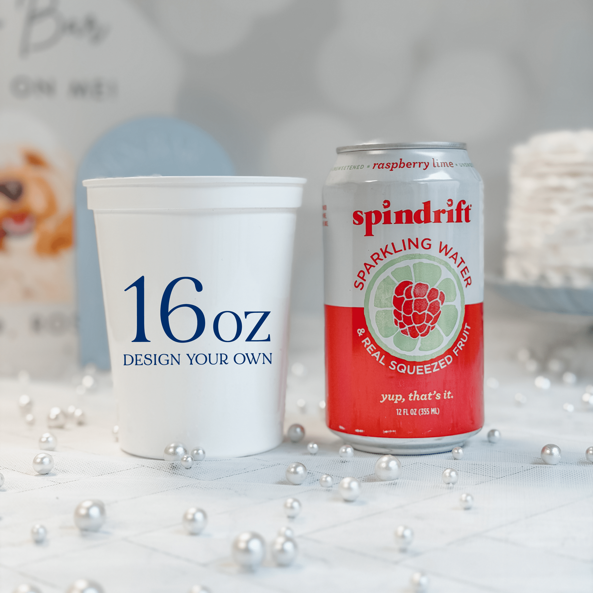 16 oz white stadium cup shown beside a 12 oz can for size comparison, custom navy design