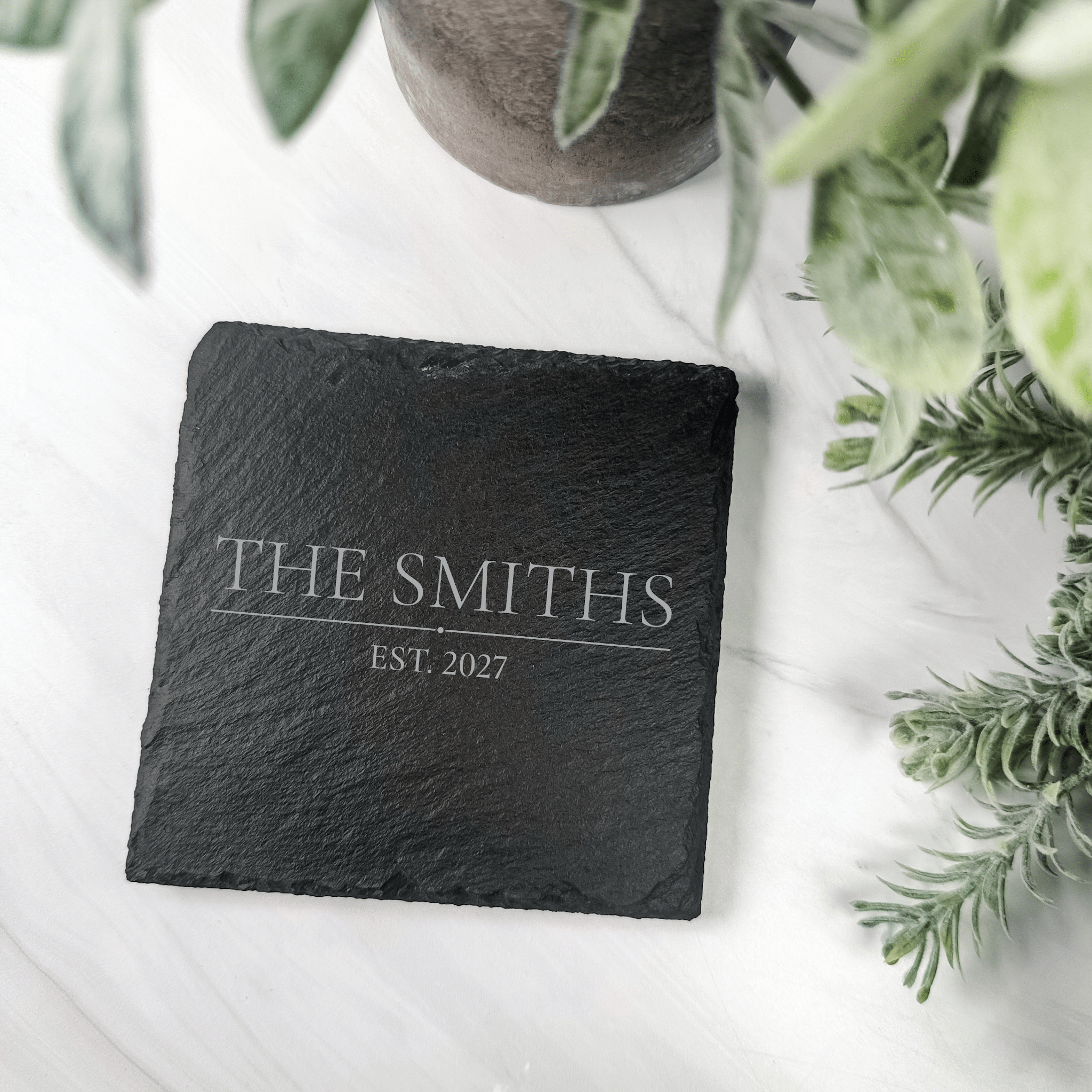 Engraved slate last name coasters in charcoal gray with light gray engraving