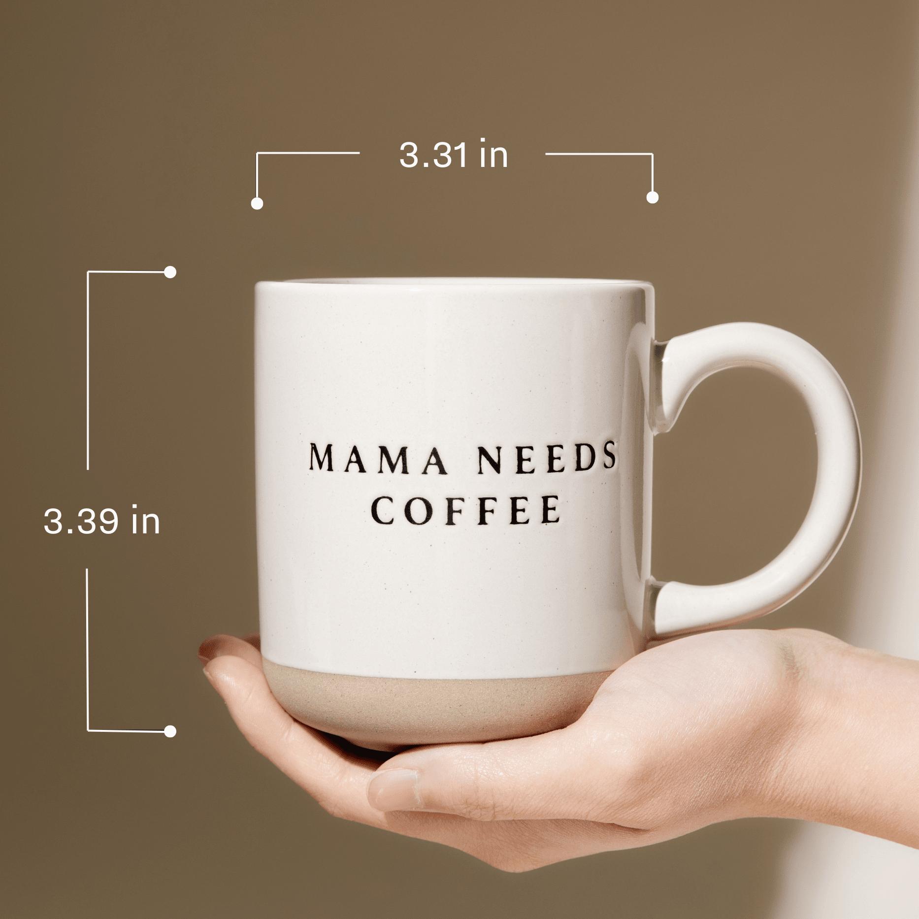 White ceramic mug with "MAMA NEEDS COFFEE" text, held in hand against tan background with dimensions shown.