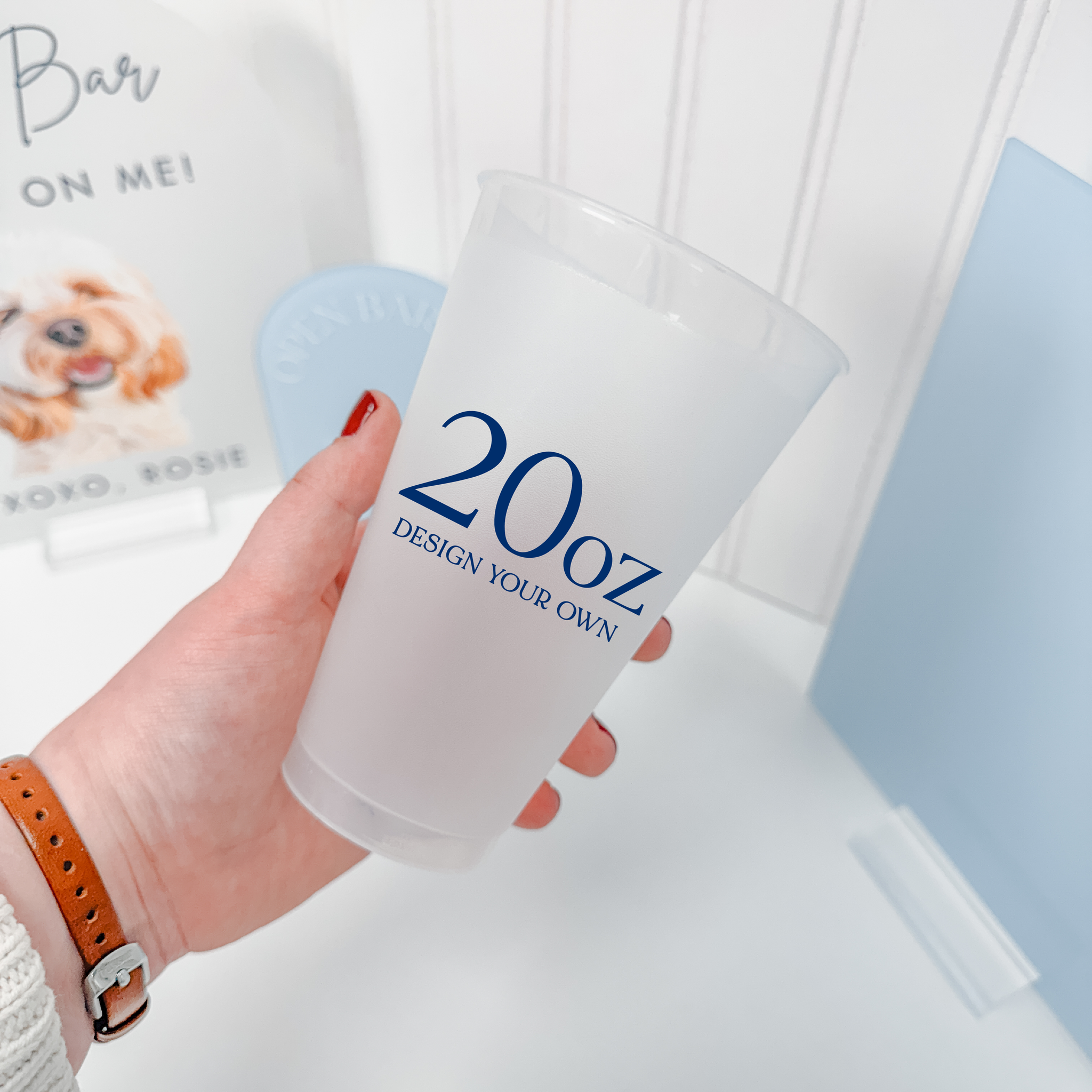20 oz frosted shatterproof cup held in hand with a custom navy design for receptions
