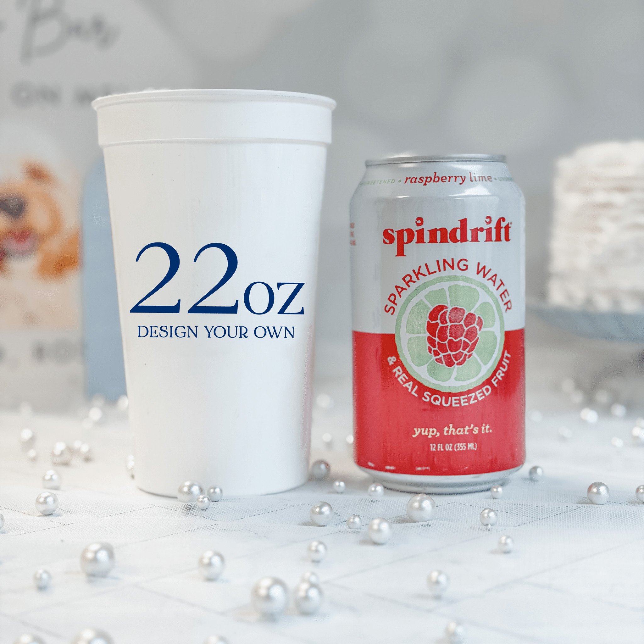 22 oz white stadium cup beside a 12 oz soda can for scale, personalized custom design