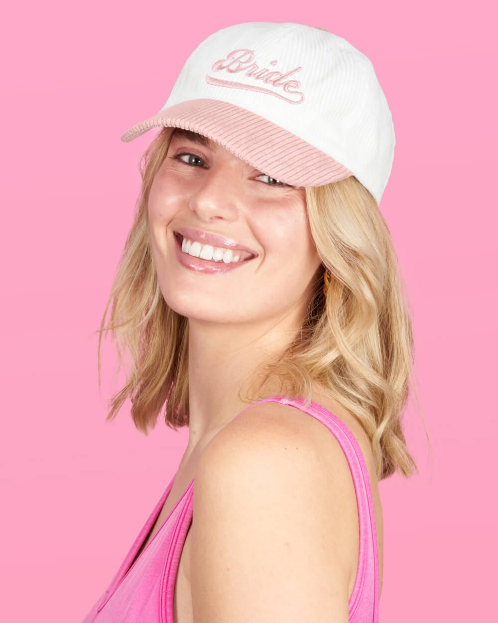 White and pink corduroy baseball cap with embroidered "Bride" text on front panel.