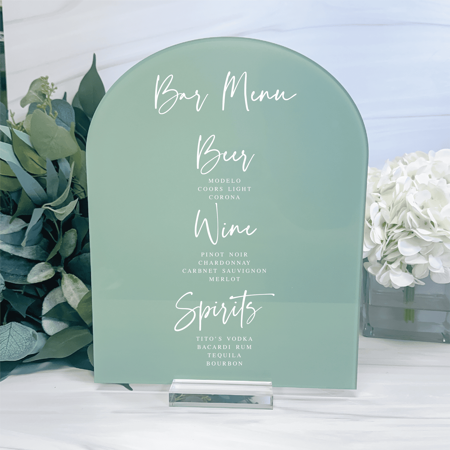Sage green arch-shaped bar menu sign with white script text listing Beer, Wine, and Spirits drink options for wedding reception.