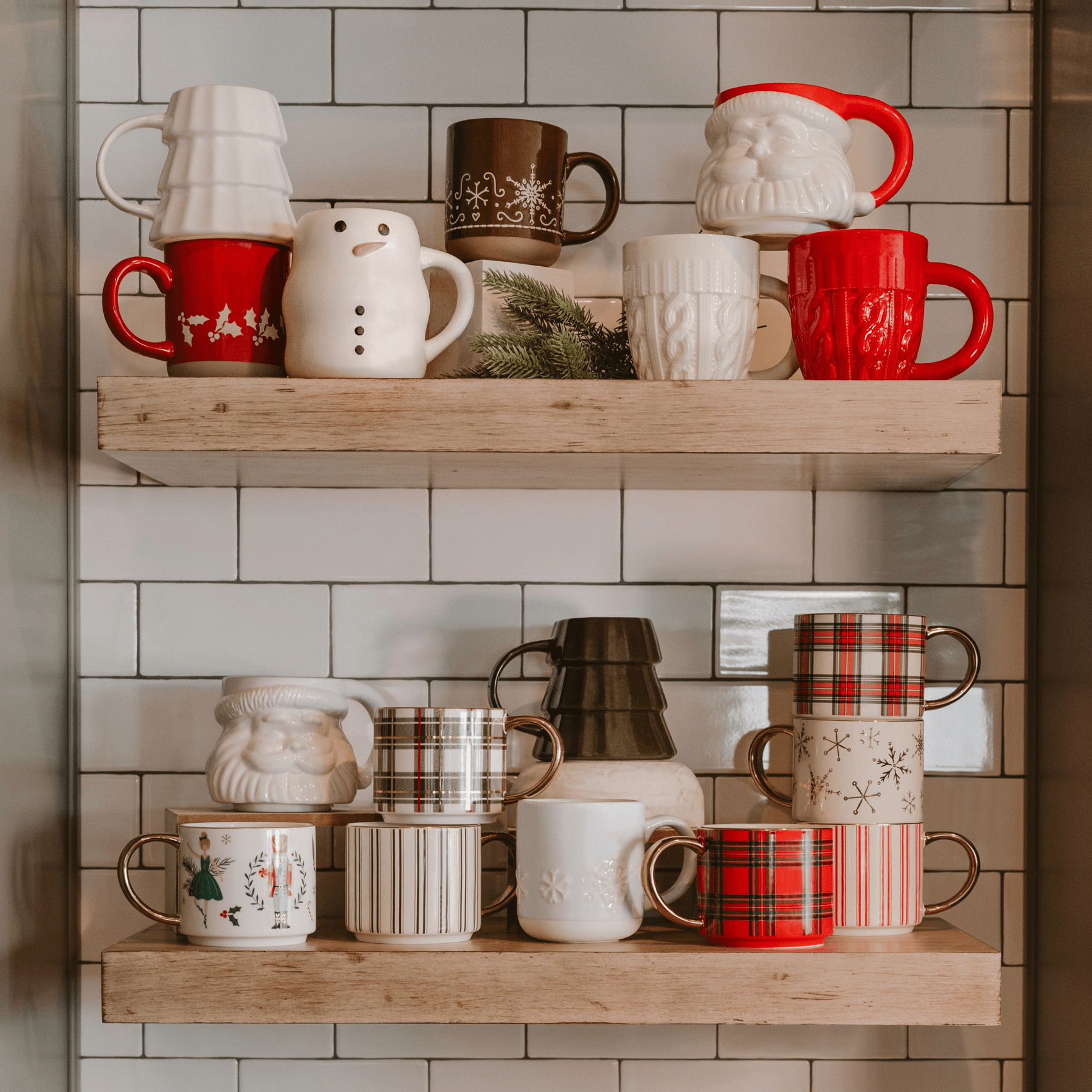 Cream ceramic mug with knitted sweater texture design and red handle, displayed on wooden shelf with holiday mugs.