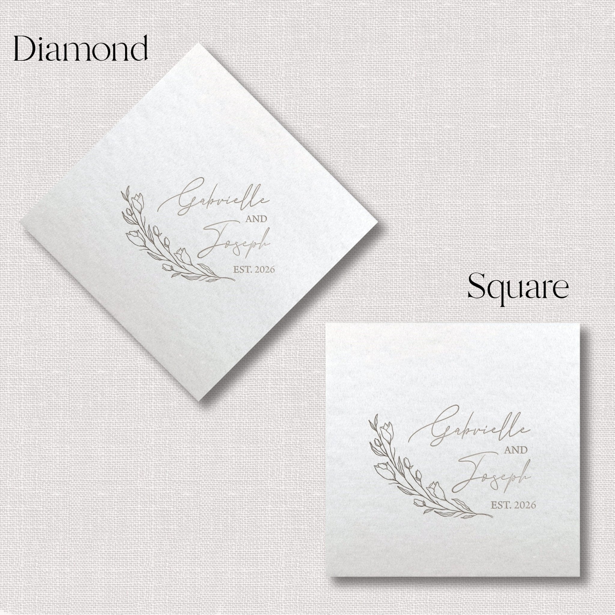 White linen napkins in diamond and square shapes with personalized floral branch design and couple names with wedding date in foil stamping.