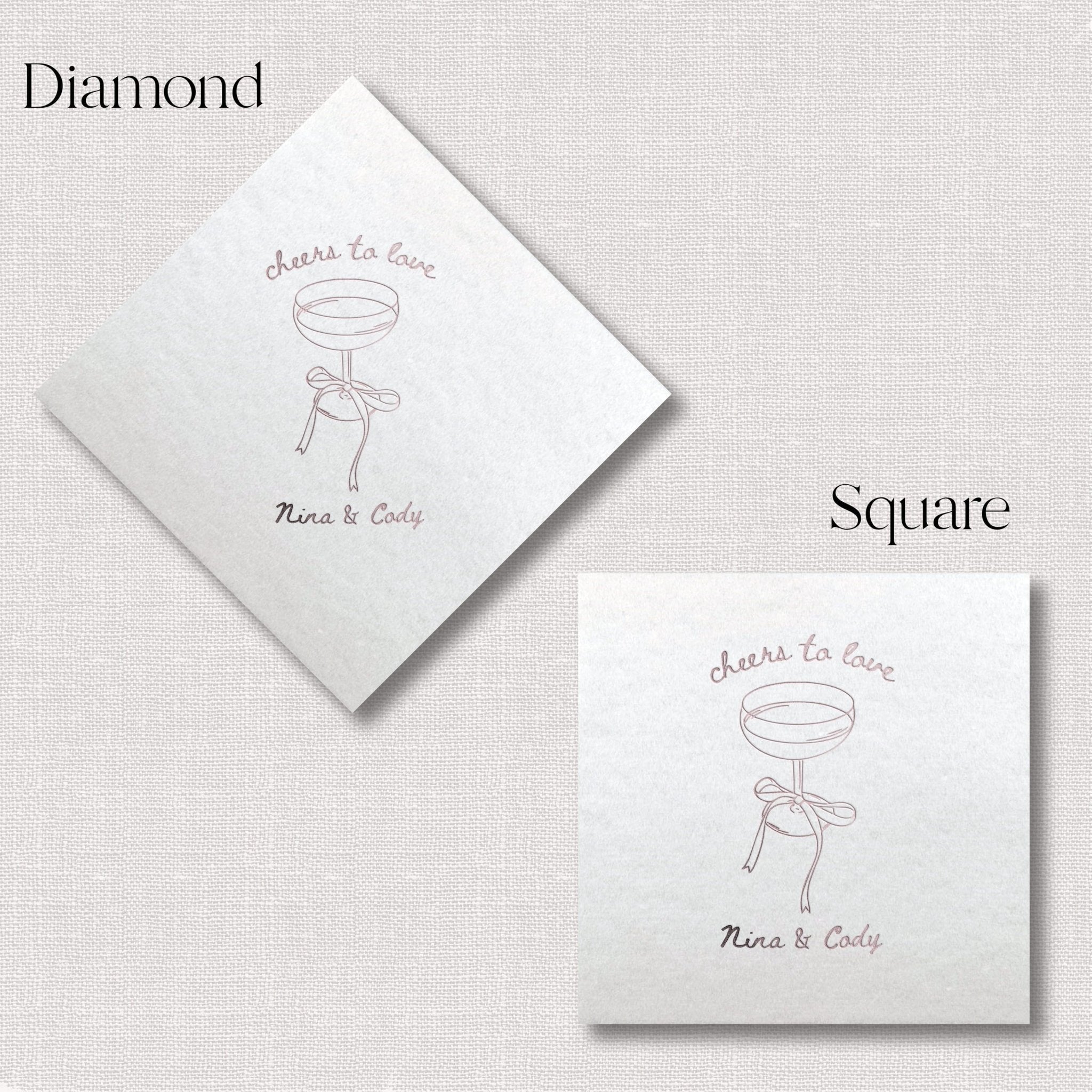 White linen napkins in diamond and square shapes with "cheers to love" text and champagne glass illustration, personalized with names.