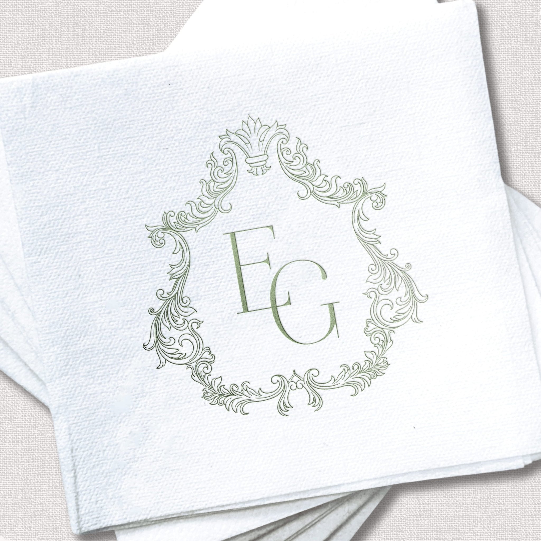 White napkin with ornate gray foil-stamped frame design and monogram letter E in the center