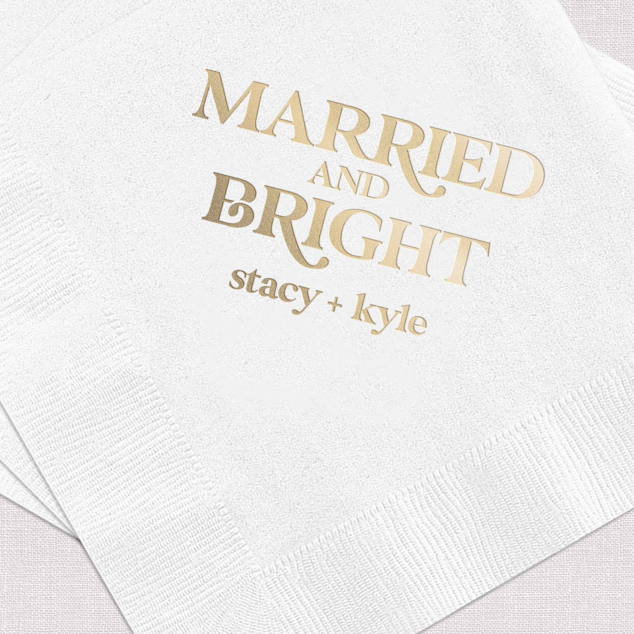 White napkins with gold foil text reading "Married and Bright" and personalized names stacy and kyle