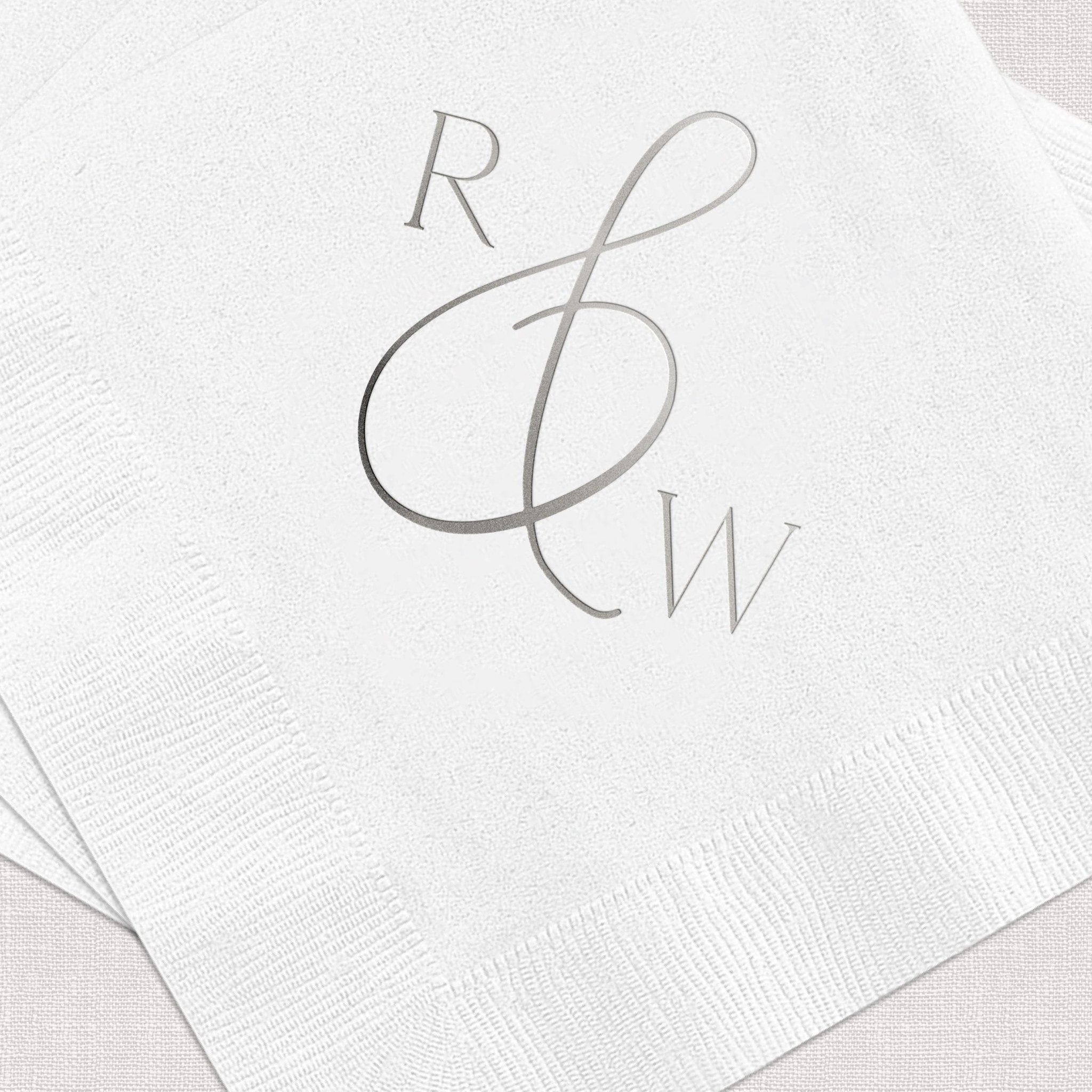 White napkin with gray foil-stamped monogram featuring R and W initials in elegant script design