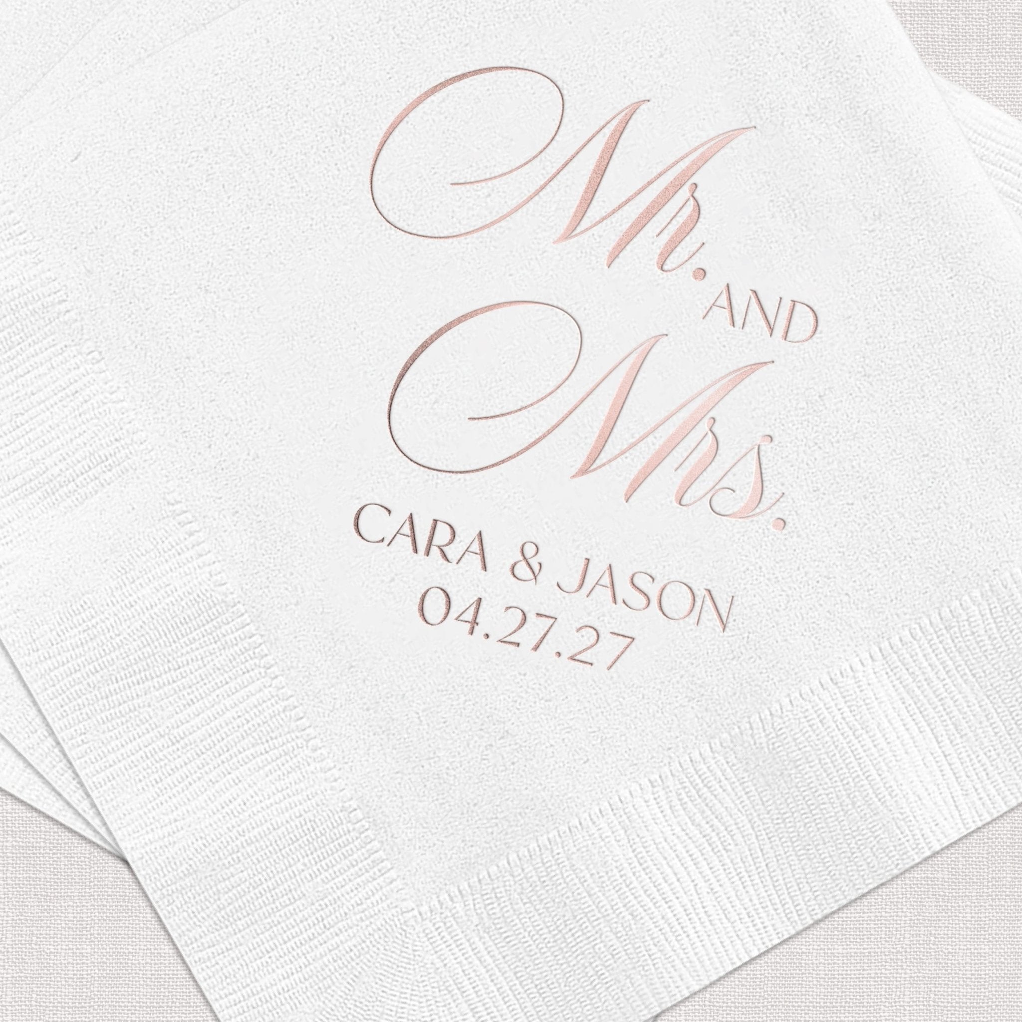 White napkin with rose gold foil stamped Mr and Mrs design, personalized with names Cara and Jason and wedding date 04.27.27