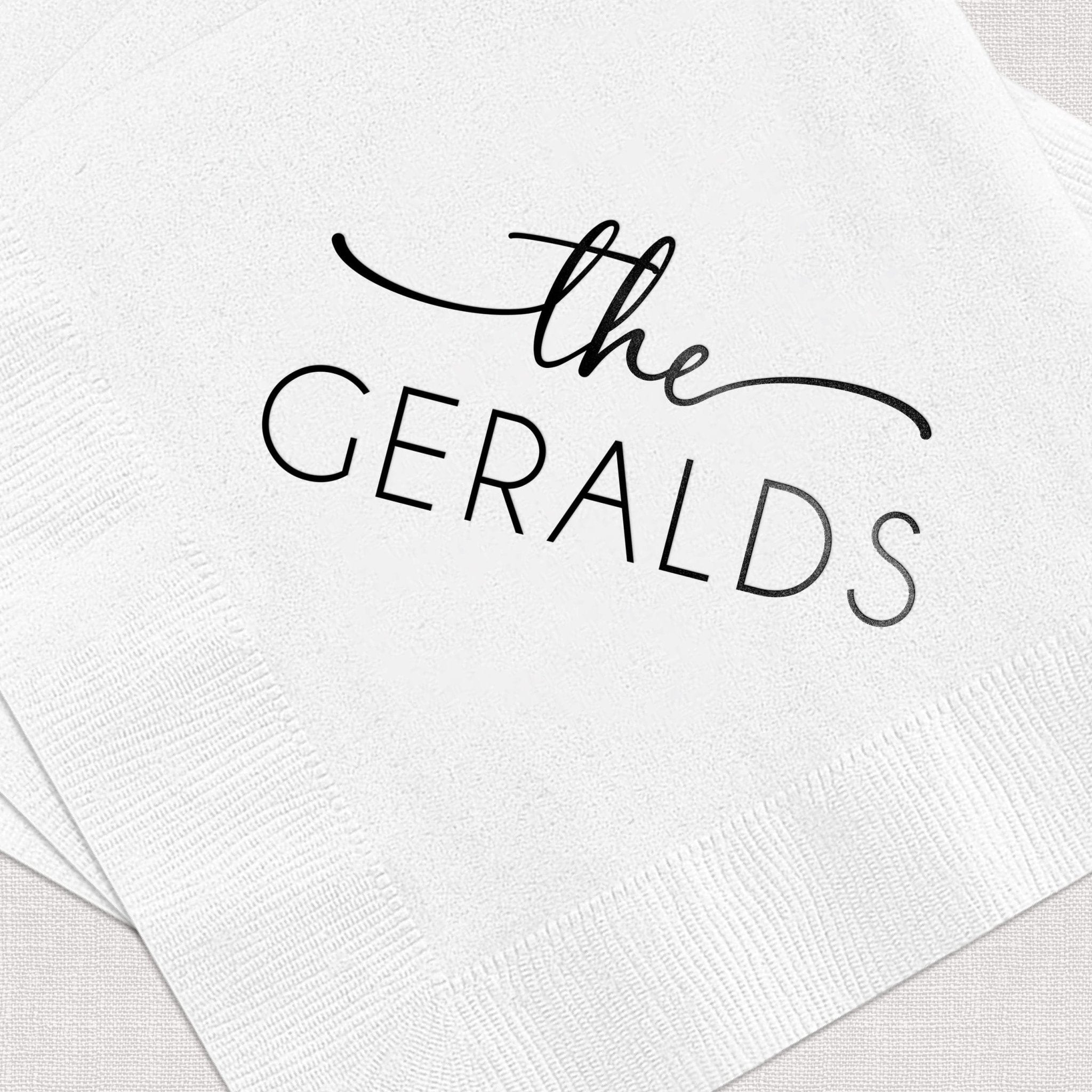 White napkins with "the GERALDS" printed in black cursive script, personalized with family last name.