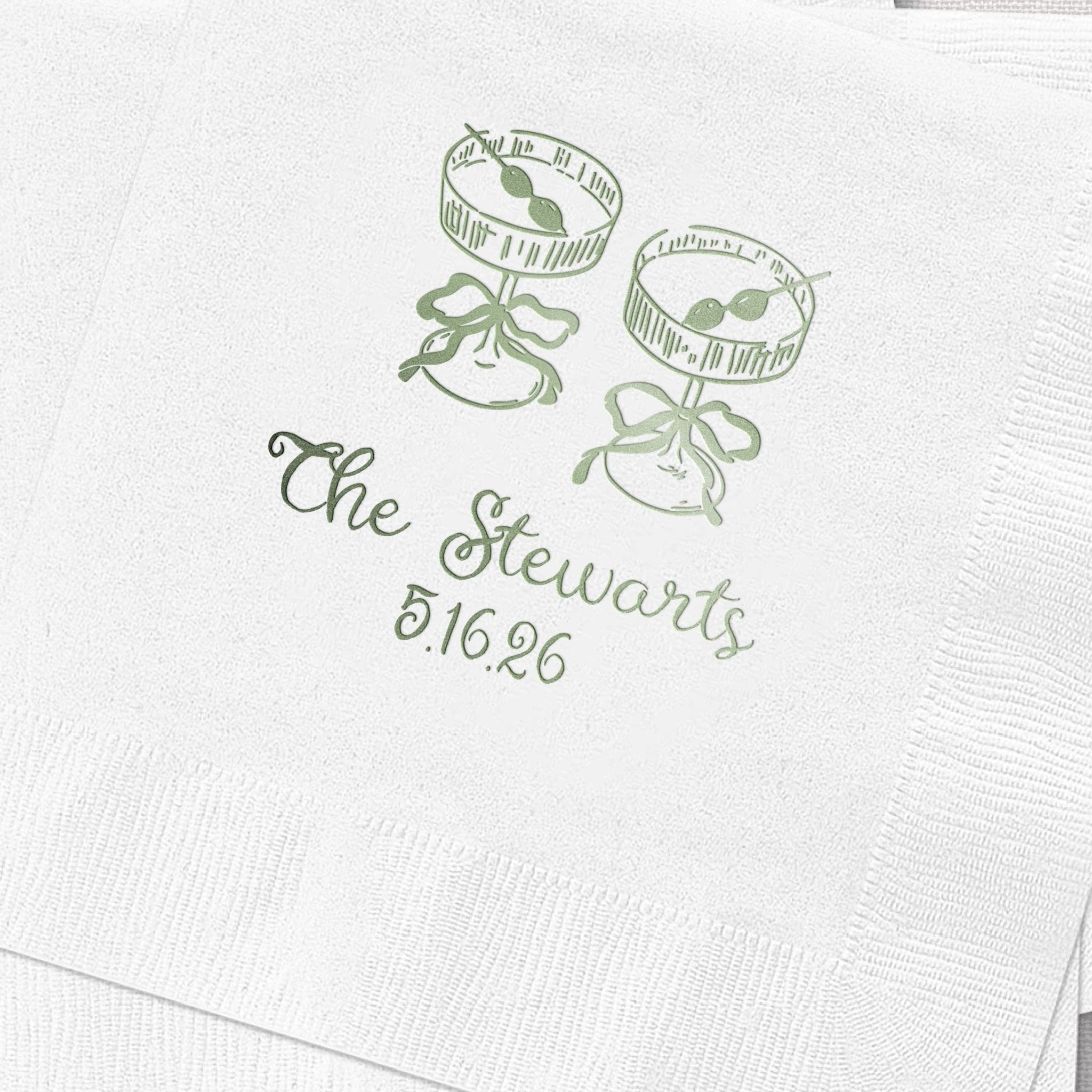 White cocktail napkin with green foil-stamped design featuring two mason jars with bows and personalized text reading "The Stewarts 8.16.96"