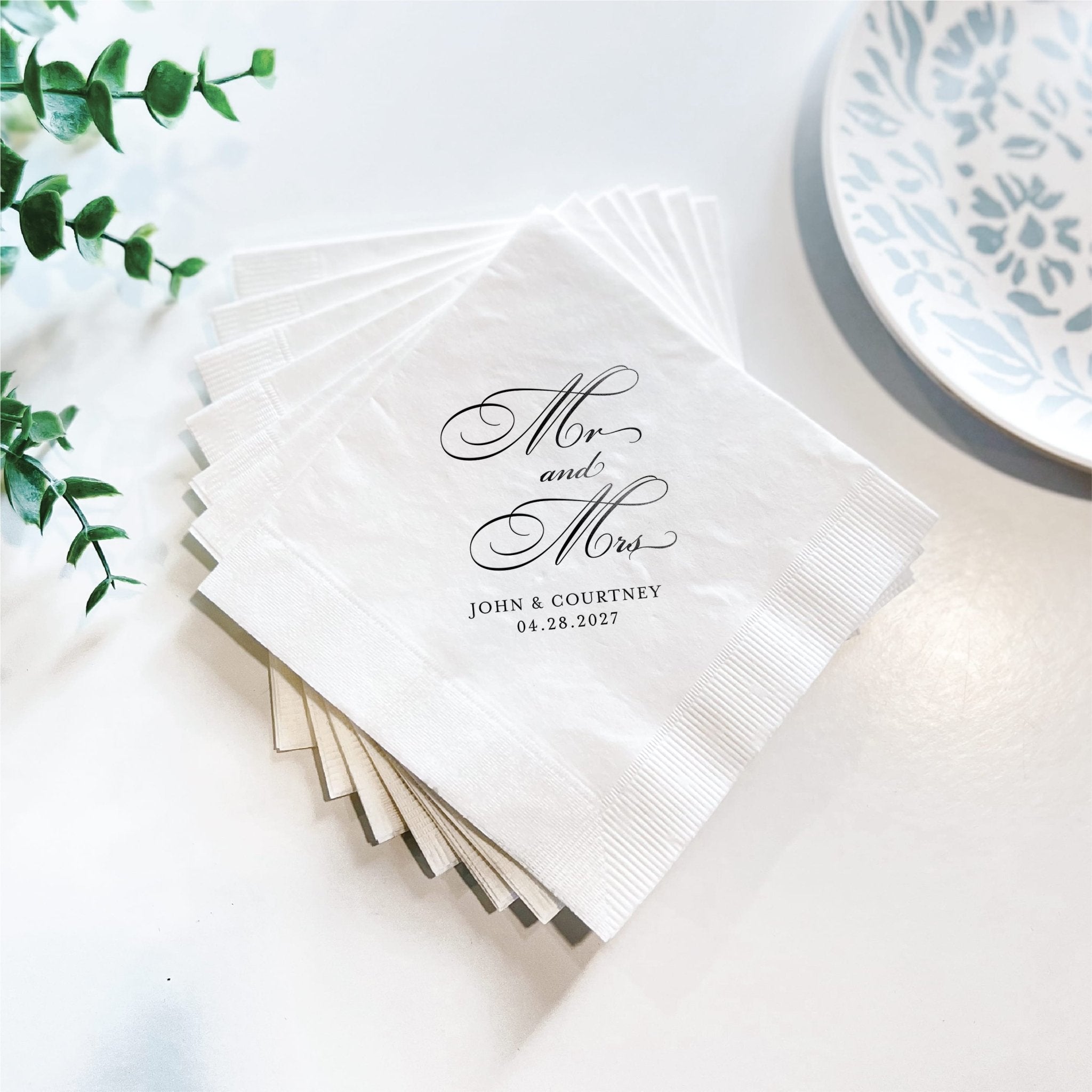 White napkins stacked with "Mr and Mrs" script and personalized names and date in black foil stamping