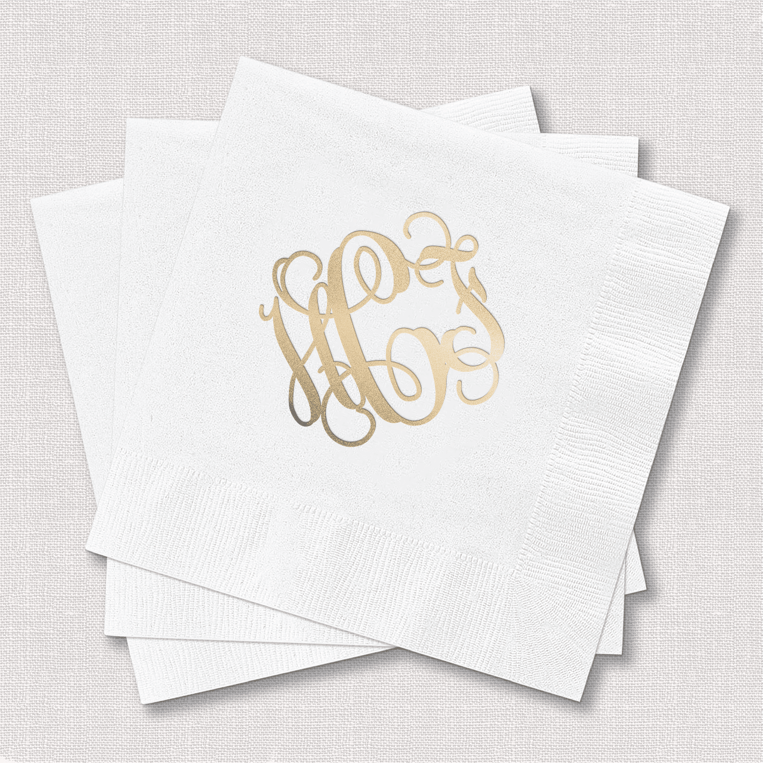 White cocktail napkins with gold foil monogram design