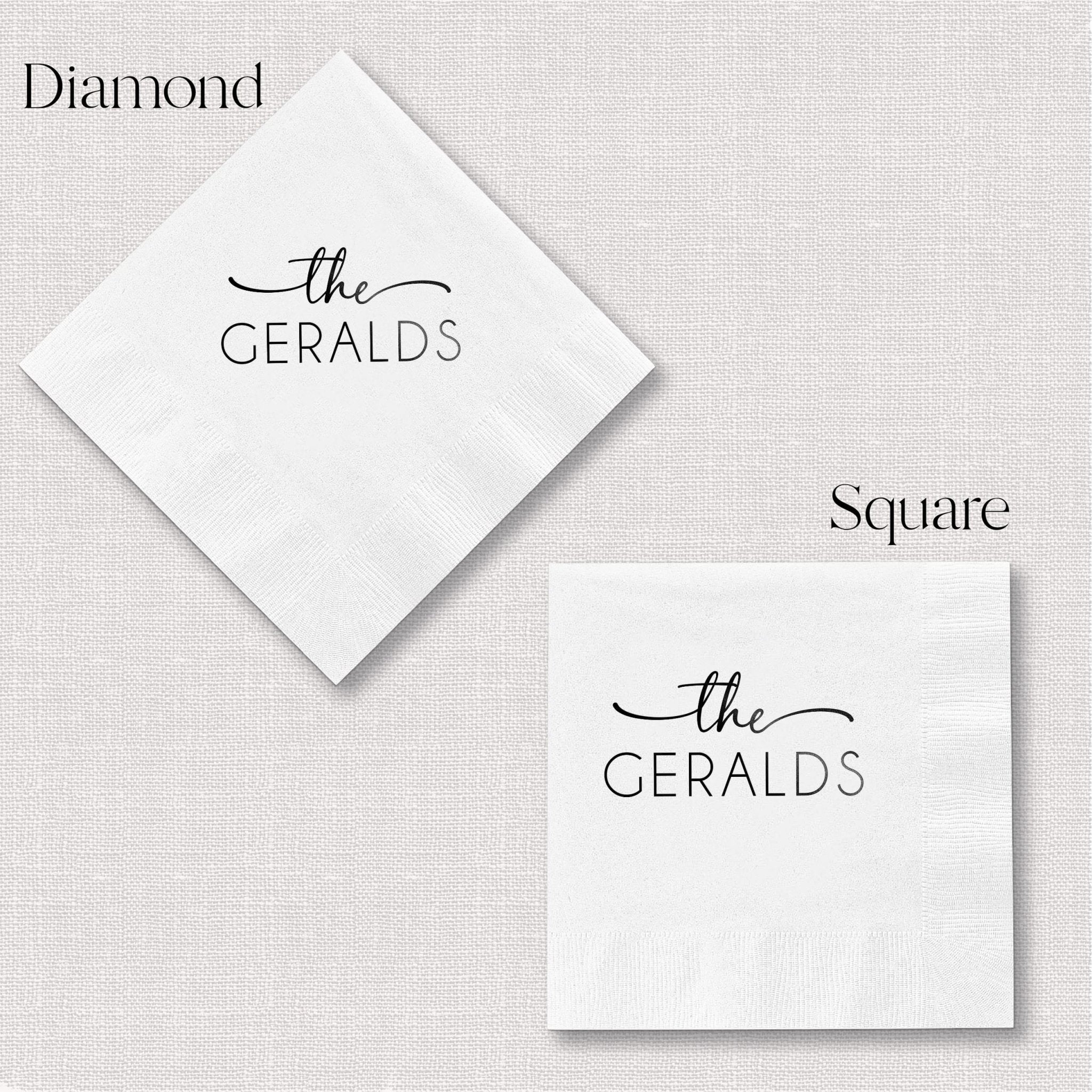 White personalized napkins in diamond and square shapes featuring "the GERALDS" in foil-stamped text.