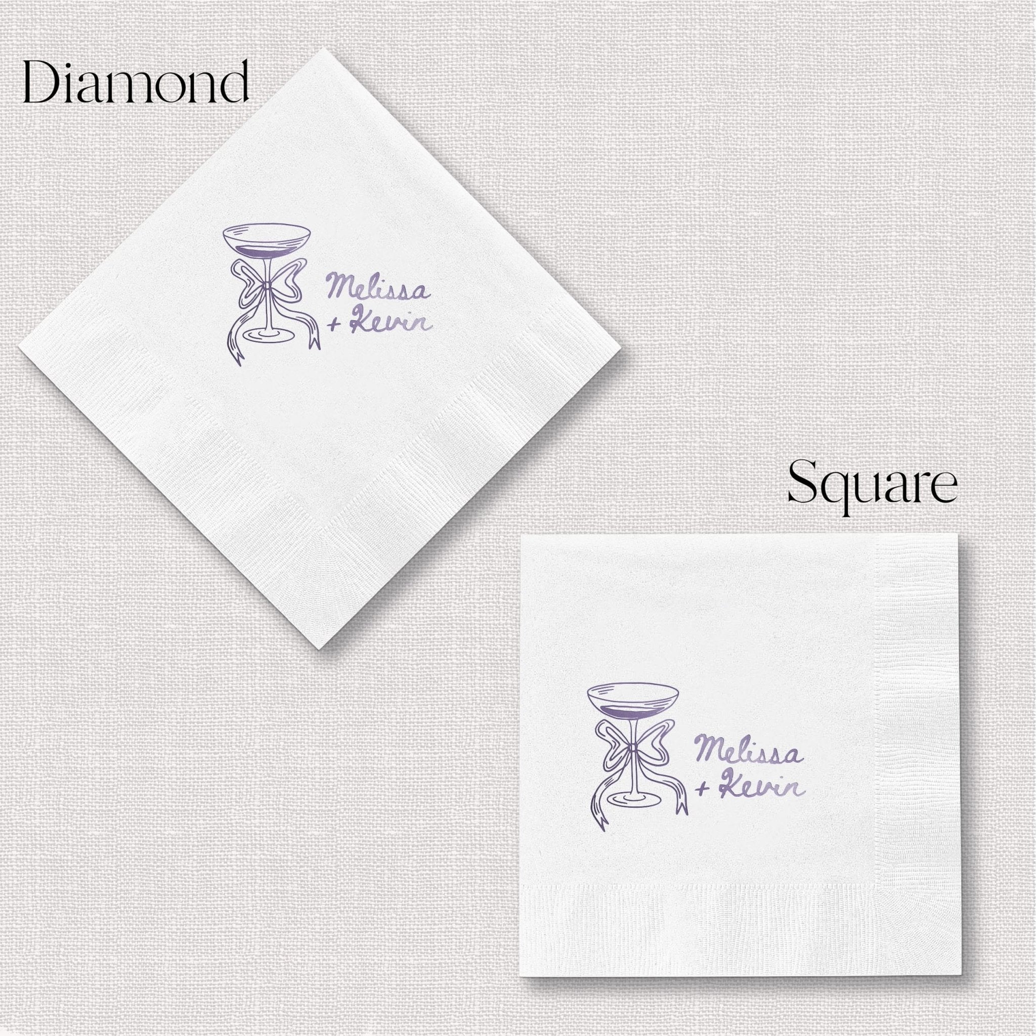 White foil-stamped napkins in diamond and square shapes with purple champagne glass design and personalized names.