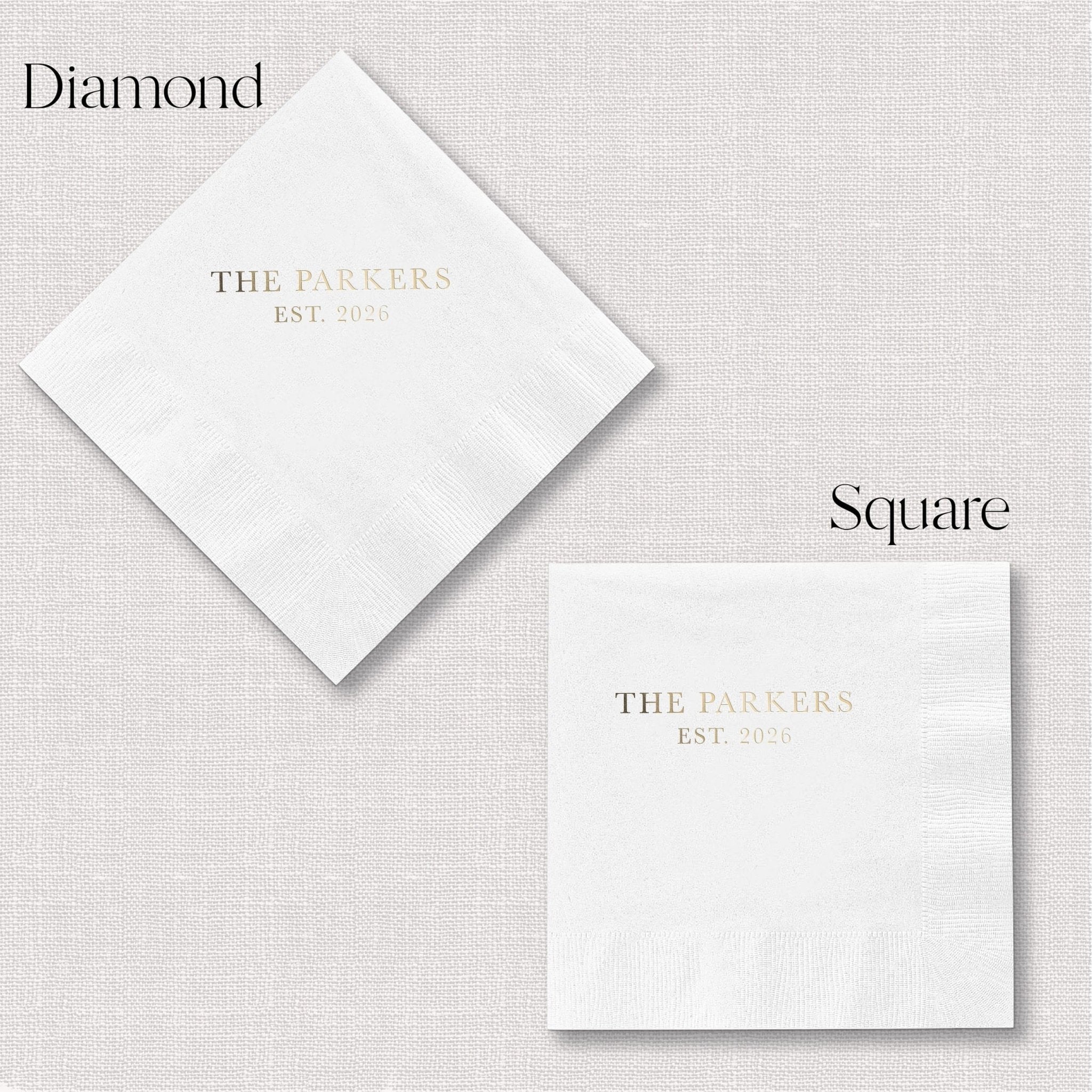 White cocktail napkins with gold foil stamping showing "The Parkers Est. 2024" in diamond and square fold options