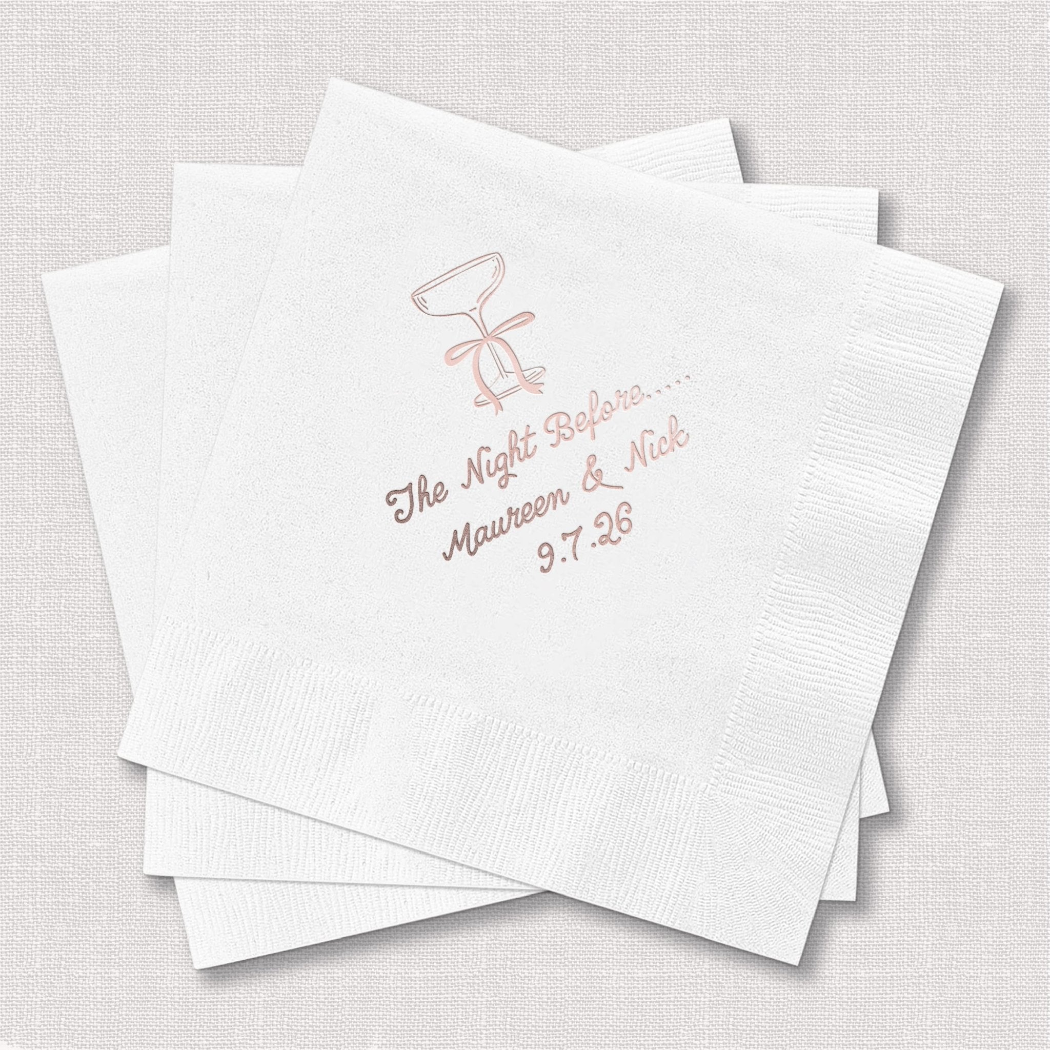 White cocktail napkins with rose gold foil stamped design featuring couple silhouette and personalized text with wedding date