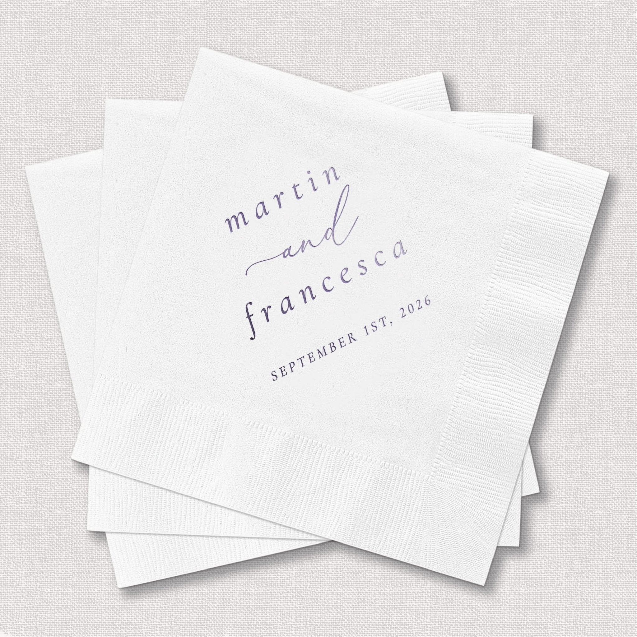 White personalized napkins with "martin and francesca" in romantic script and "september 1st 2025" printed in gray foil.