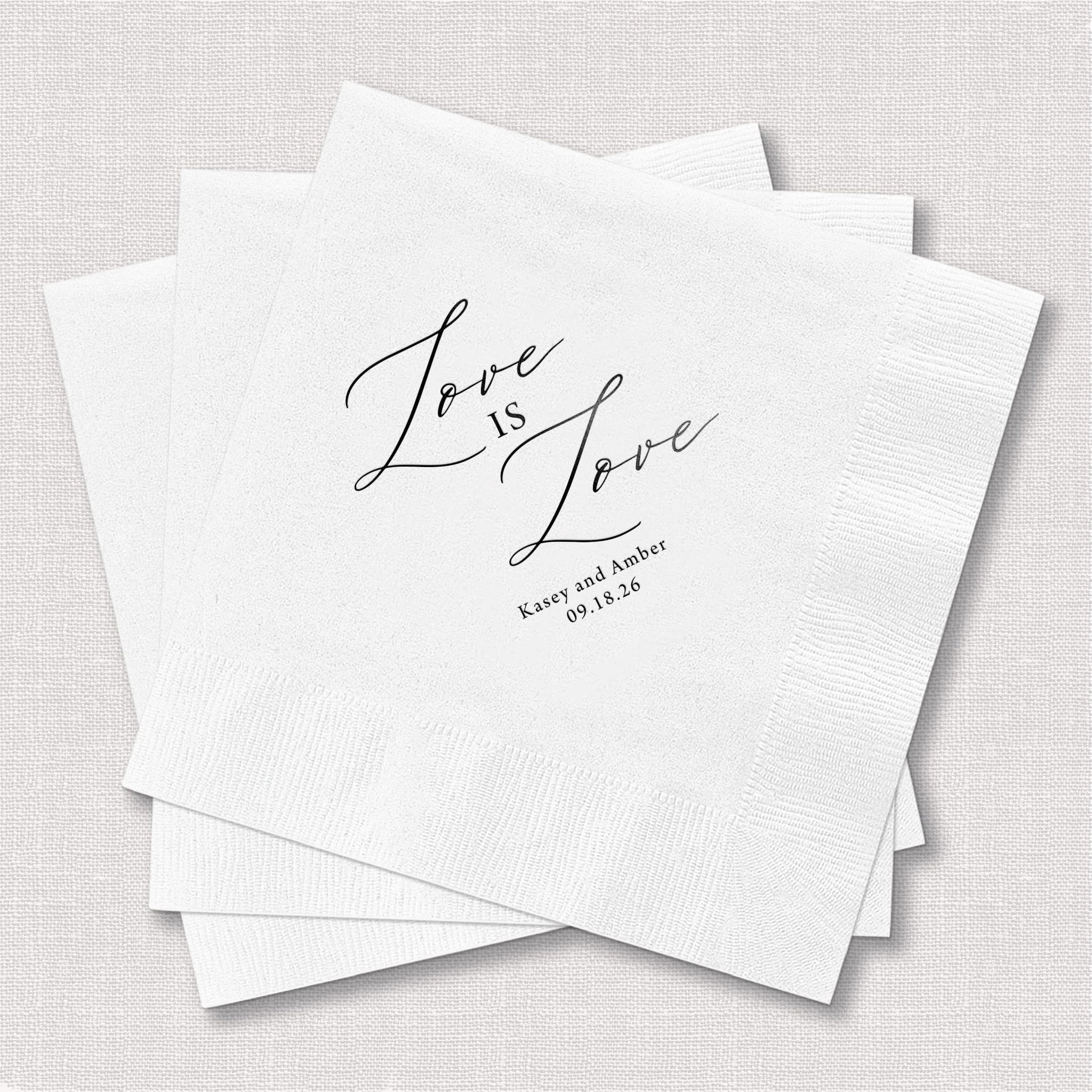 White foil-stamped napkins with "Love is Love" script and personalized names and date underneath