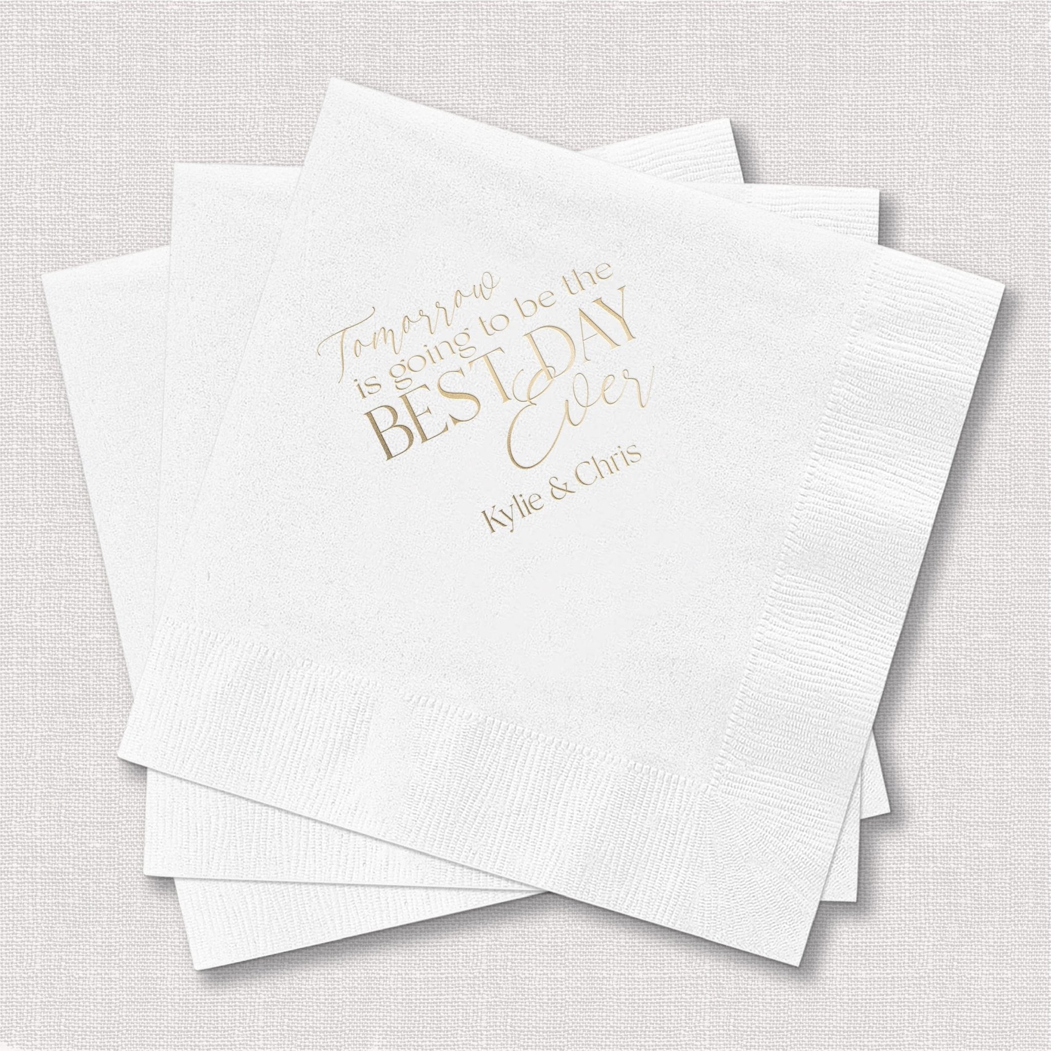 Stack of white cocktail napkins with gold foil text reading "Tomorrow is the BEST DAY ever" and "Mr & Mrs"