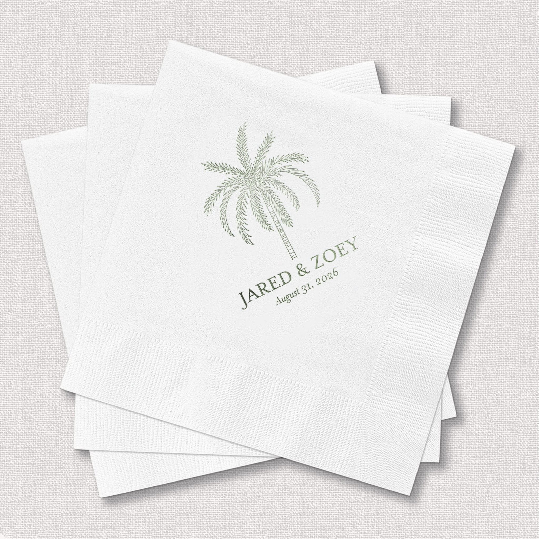 White cocktail napkins with palm tree design and "Jared & Zory" personalization in foil stamping