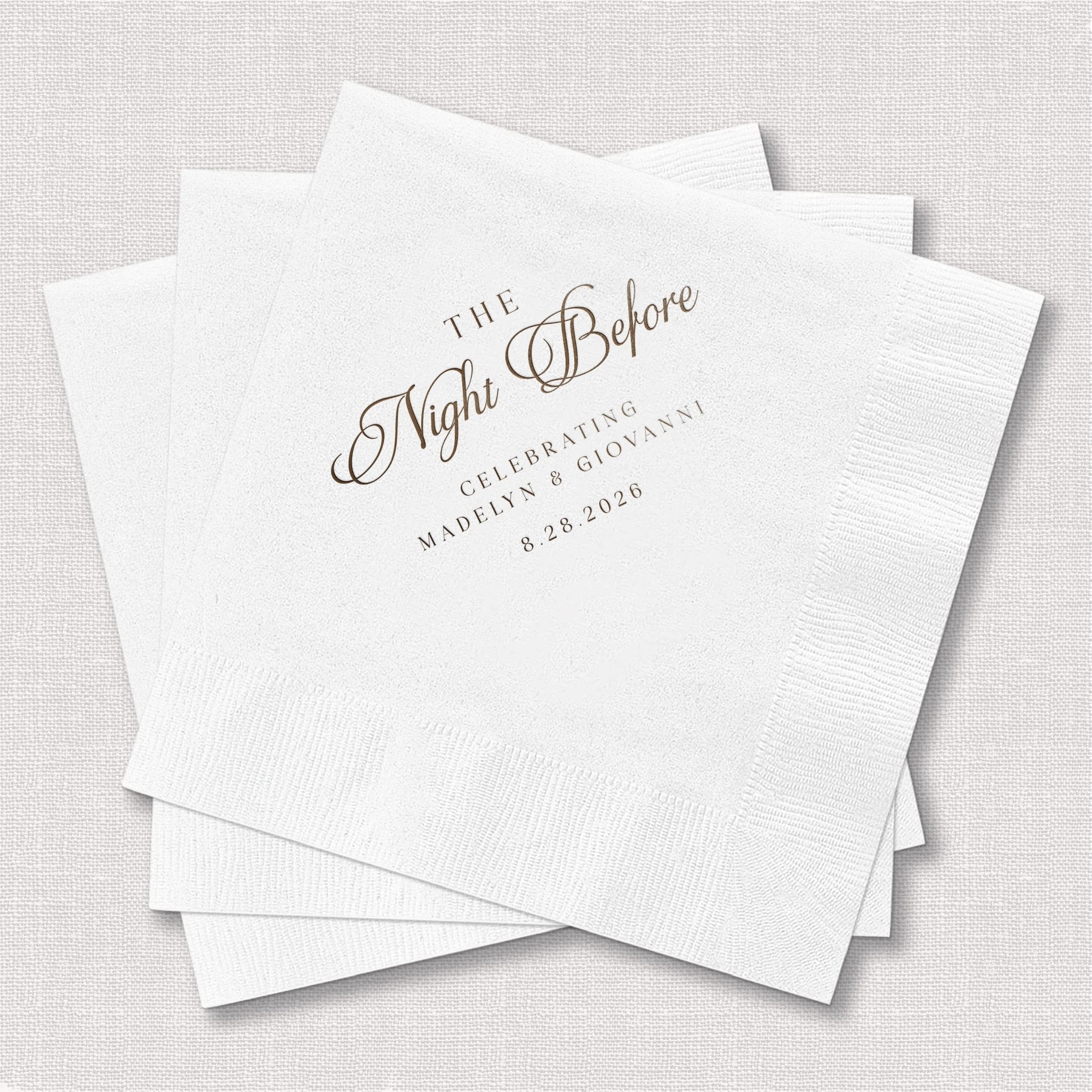 White foil-stamped napkins with "The Night Before" script text and rehearsal dinner details in gray.