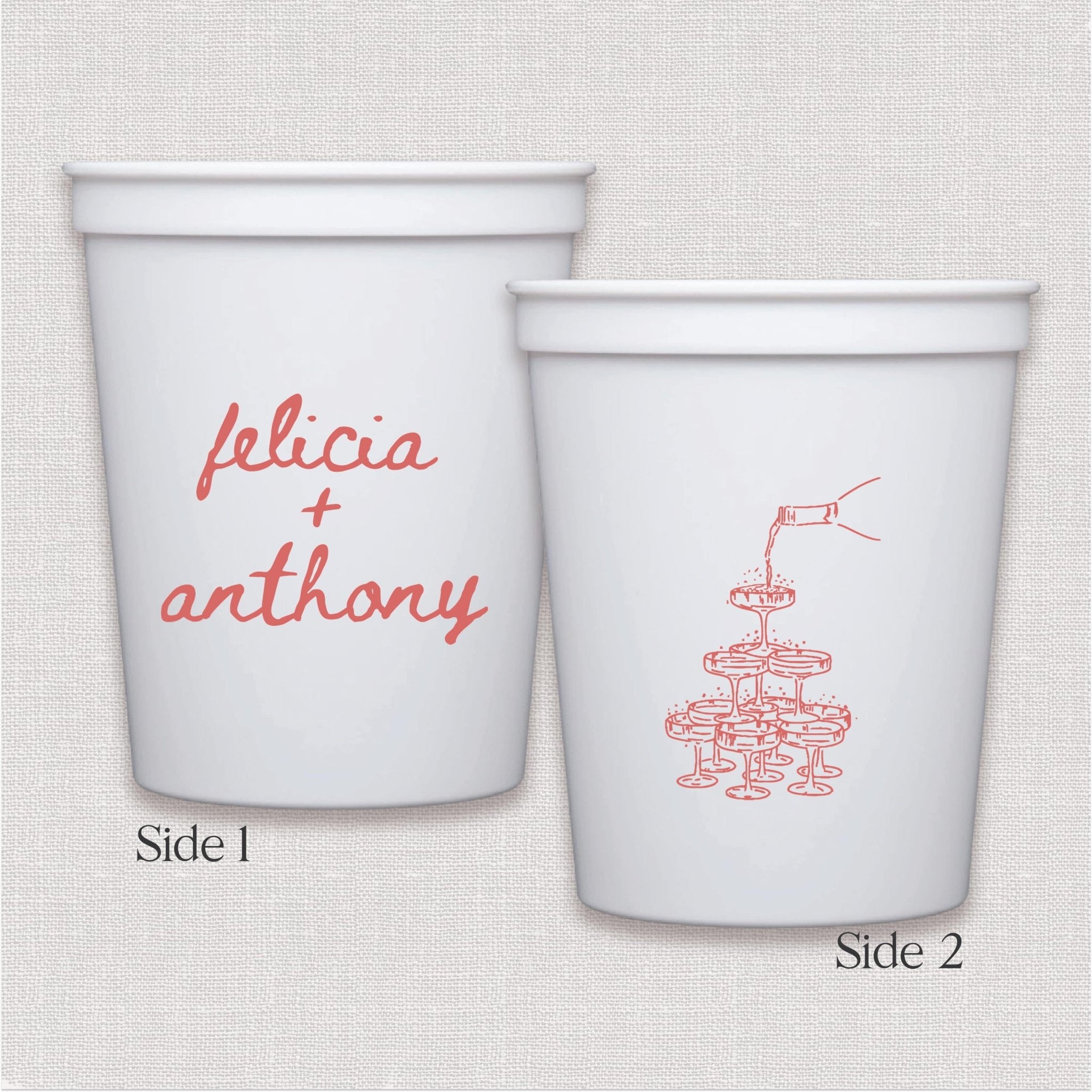 White stadium cup with personalized names in coral script and champagne tower illustration on reverse side