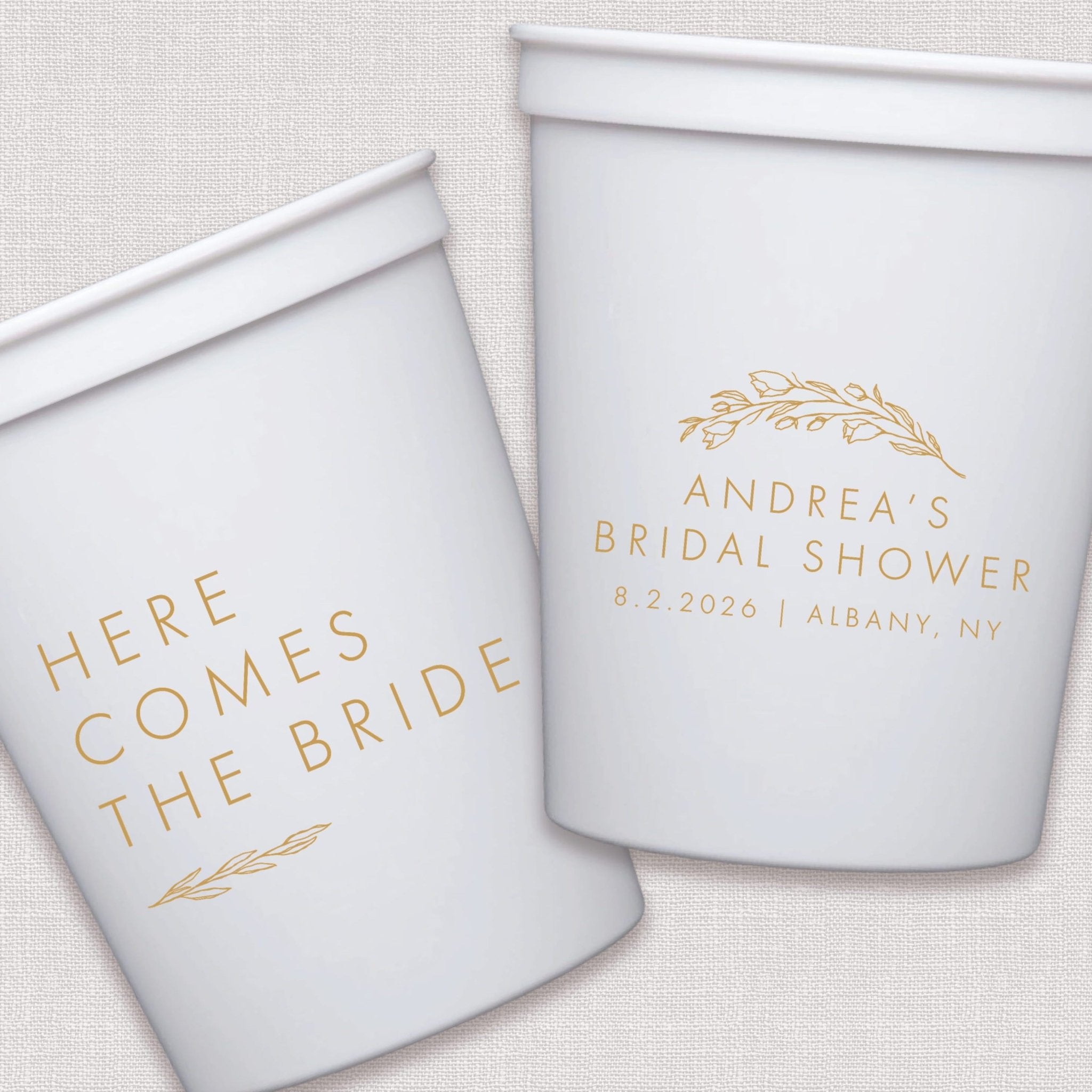 White stadium cups with gold foil bridal shower text and floral wreath design