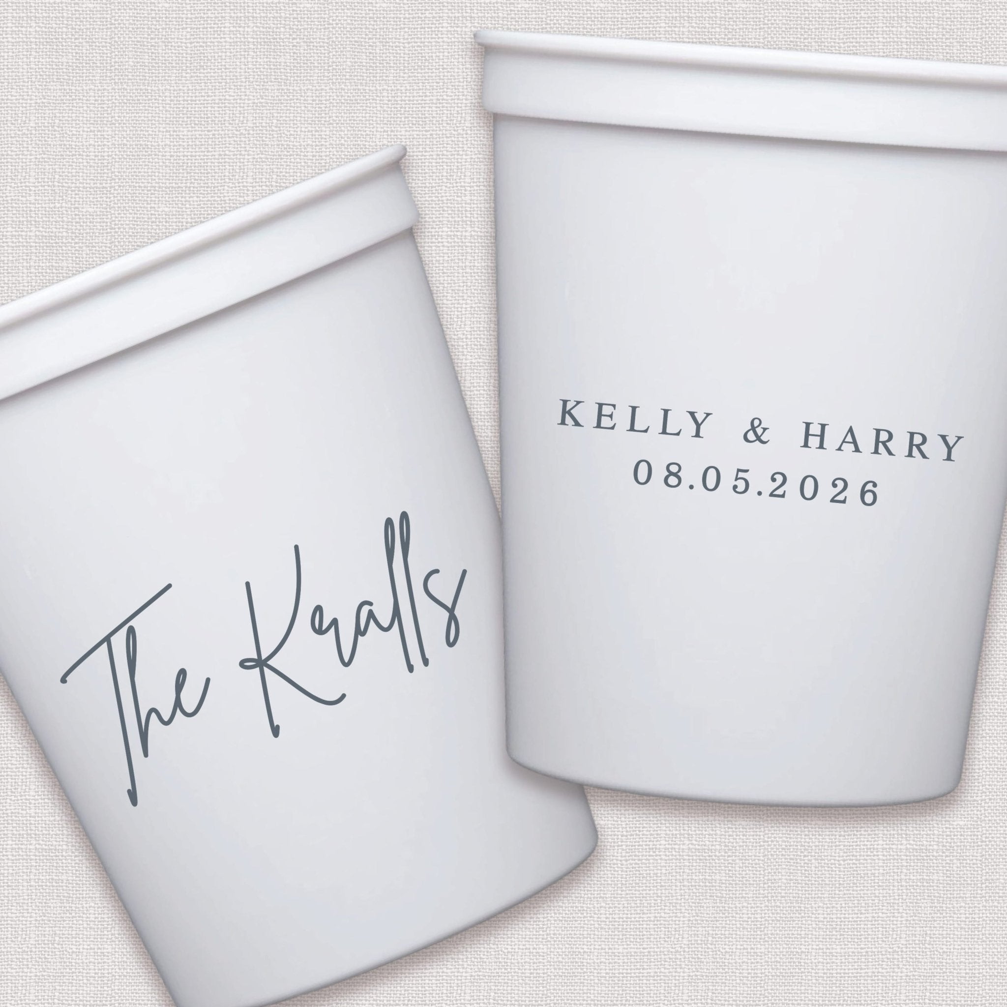White stadium cups with personalized couple names and wedding date in script text