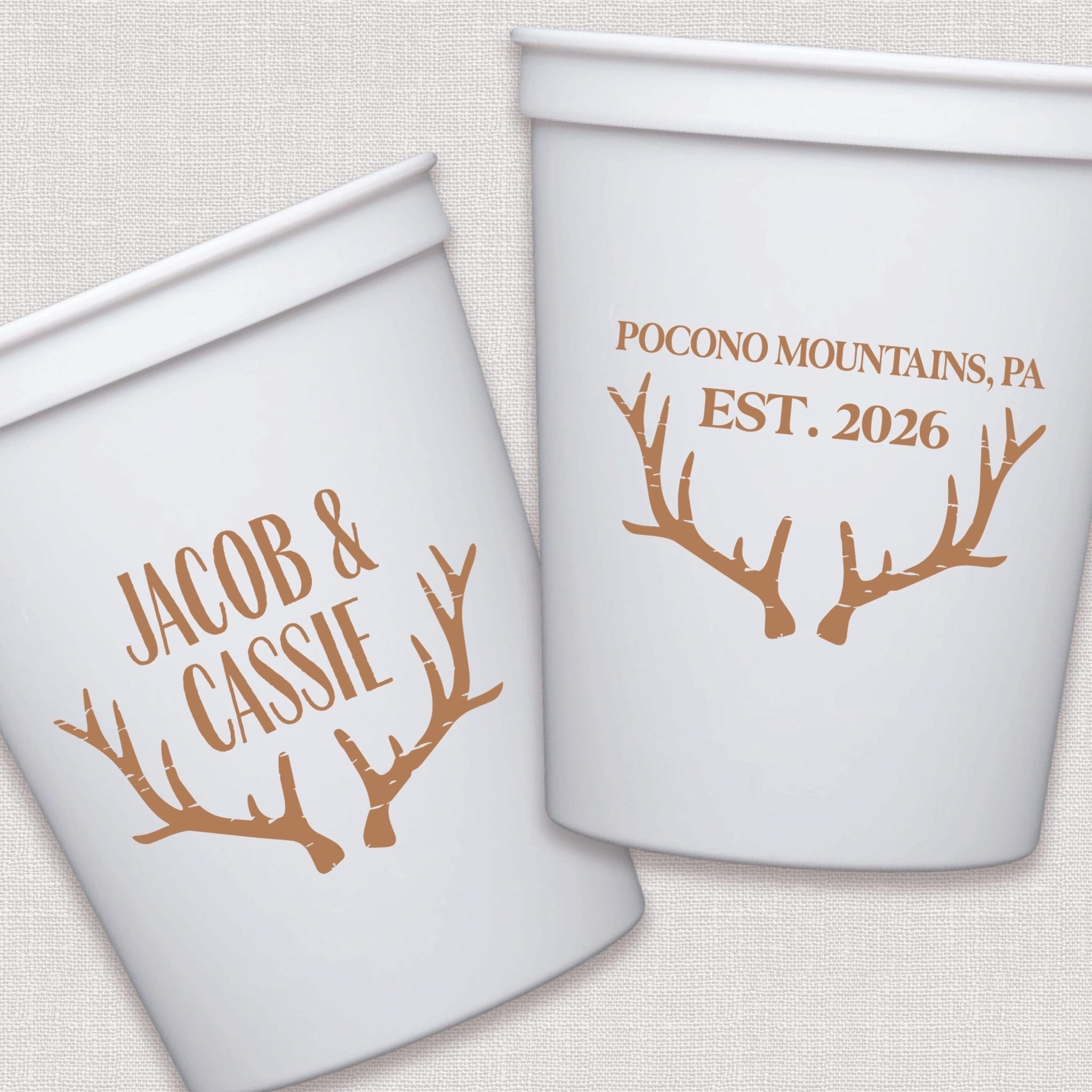 White stadium cups with personalized couple names and antler design in copper foil print