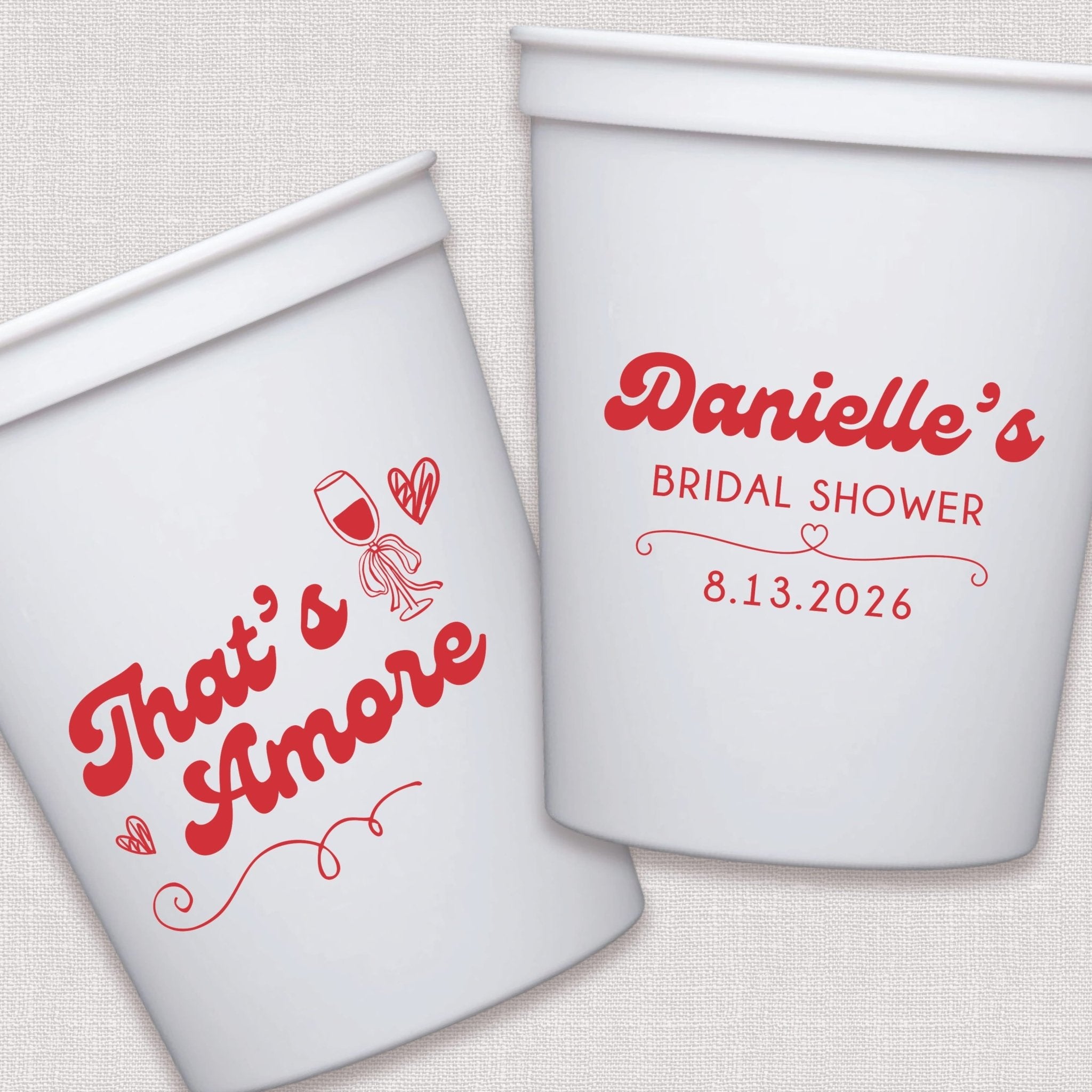 White stadium cups with red script text and decorative heart design for bridal shower event