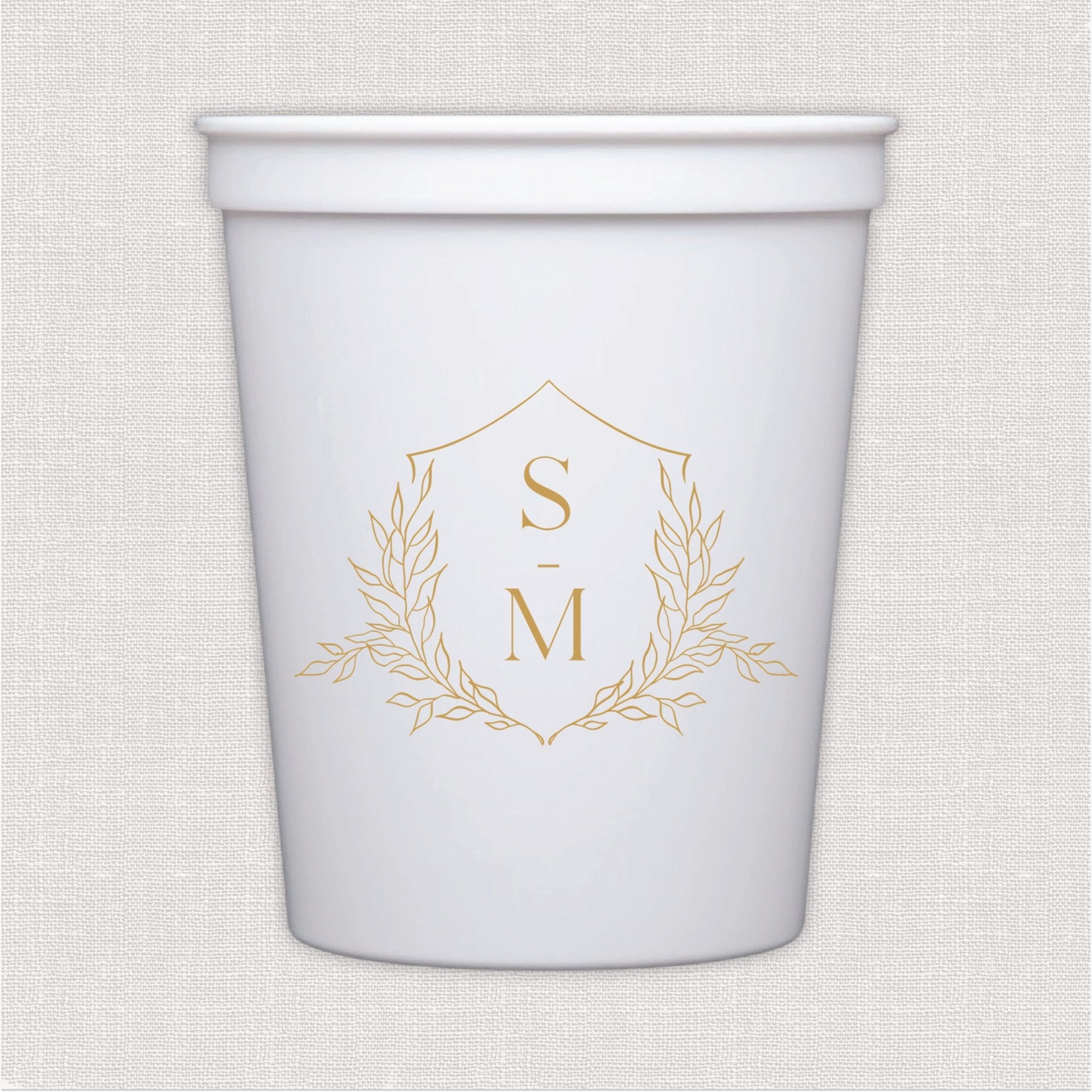 White stadium cup with gold monogram wreath design
