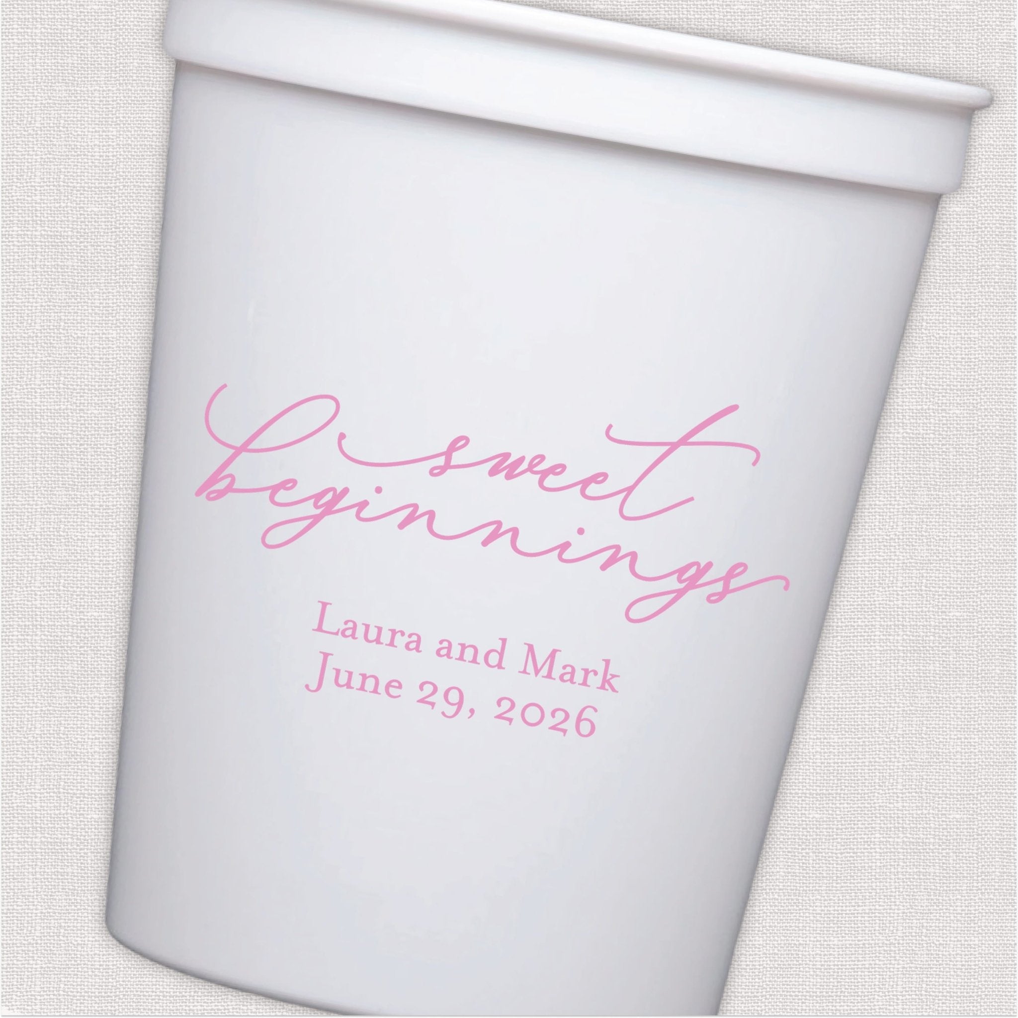 White stadium cup with pink script wedding text and personalized couple names and date design