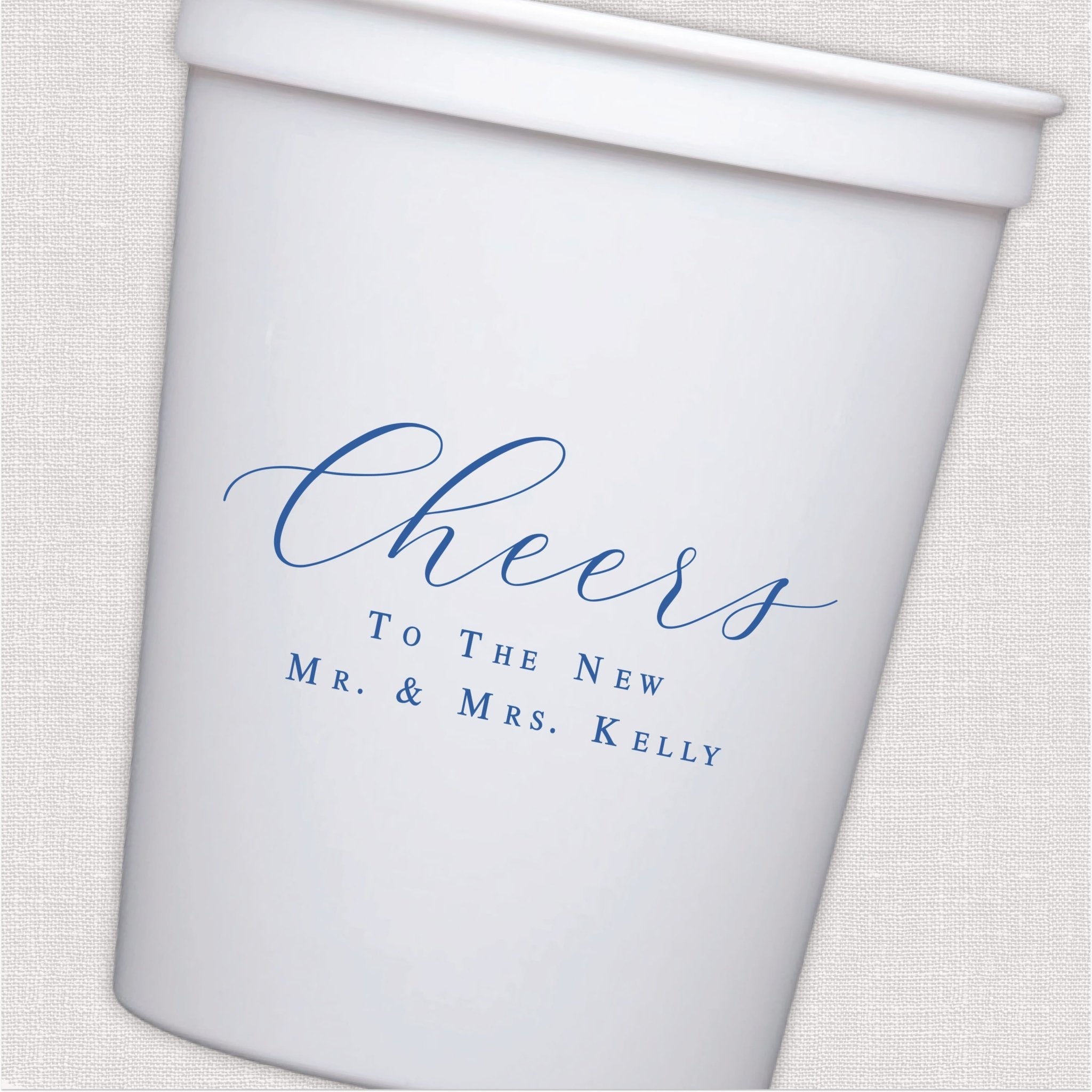 White stadium cup with blue script wedding toast design and personalized couple text