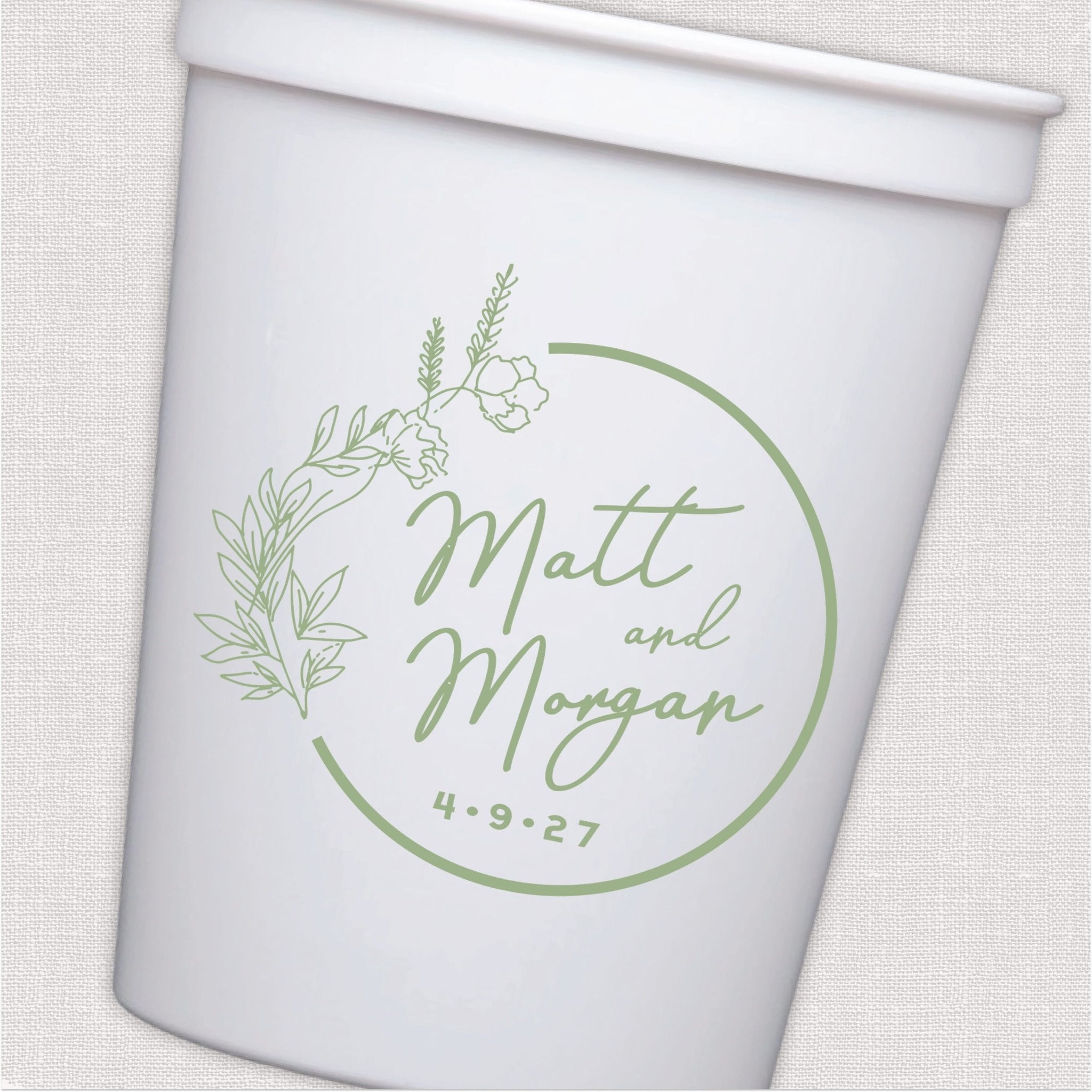 White stadium cup with sage green botanical wreath and personalized wedding text design