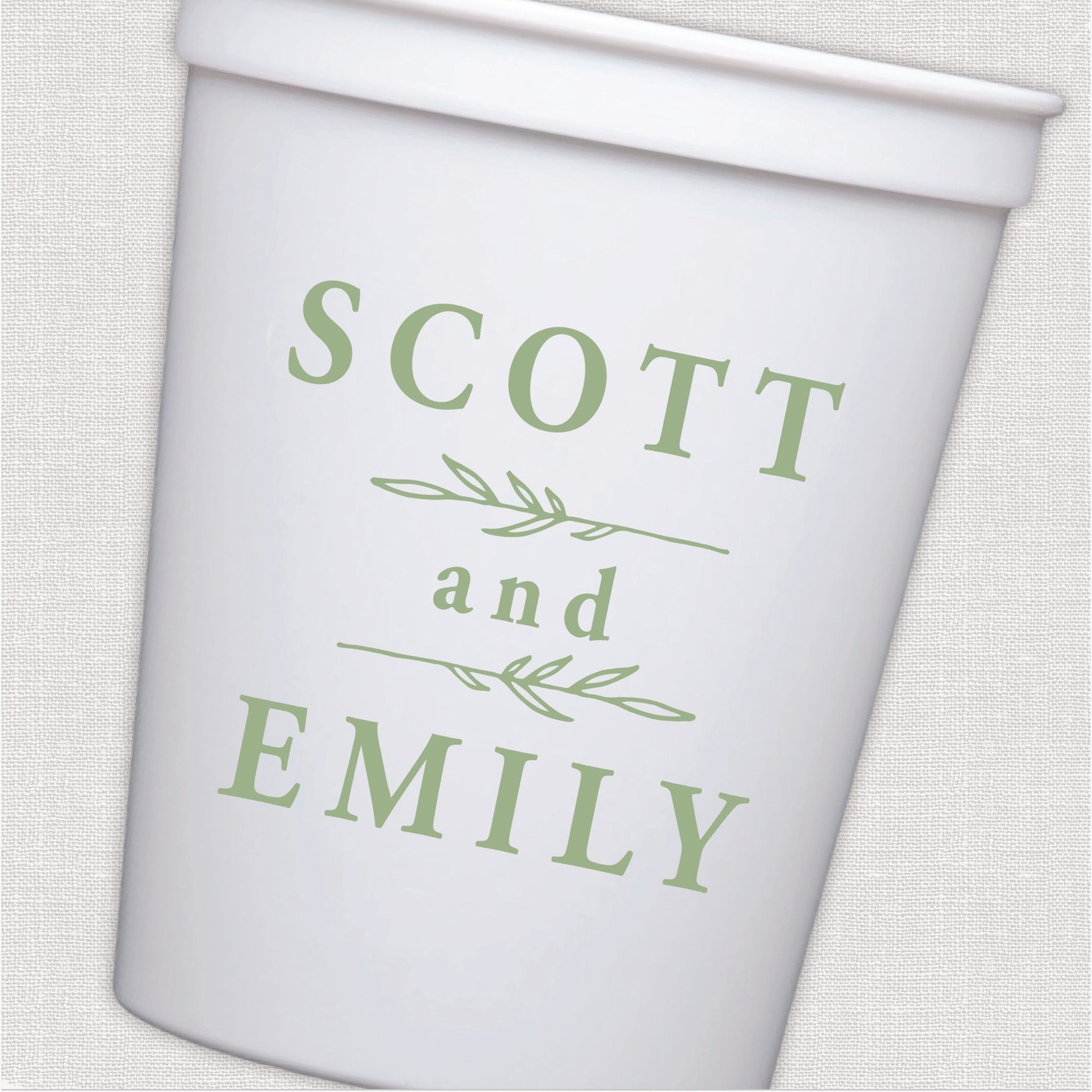White stadium cup with sage green personalized couple names and leafy branch design