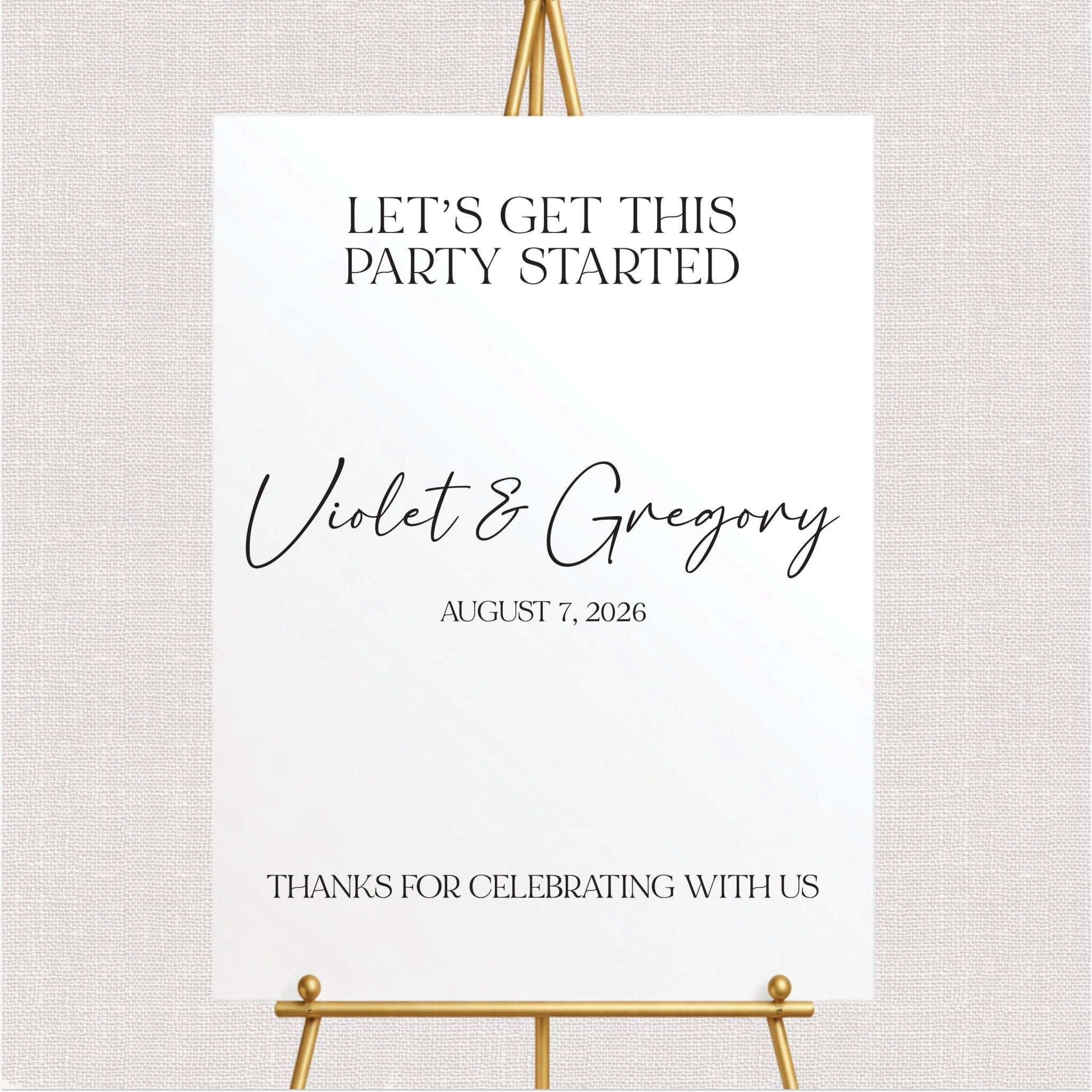 White welcome sign with personalized couple names and wedding date in script and sans-serif fonts