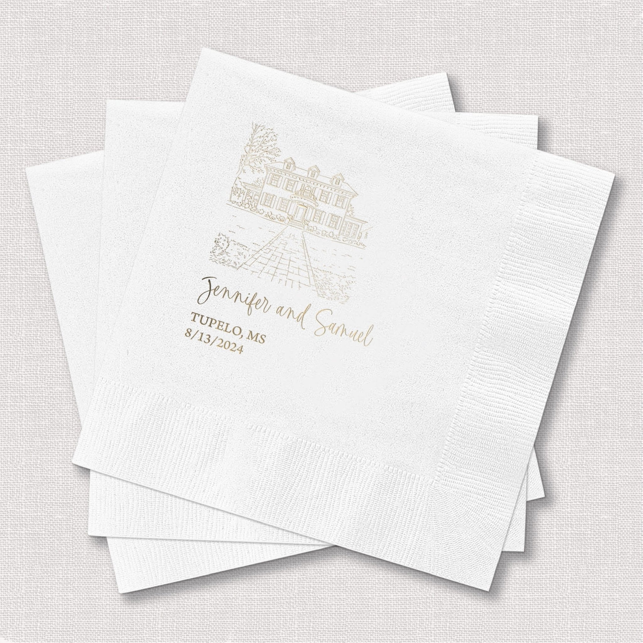 Stack of white cocktail napkins with gold foil venue illustration and personalized names and date printed below