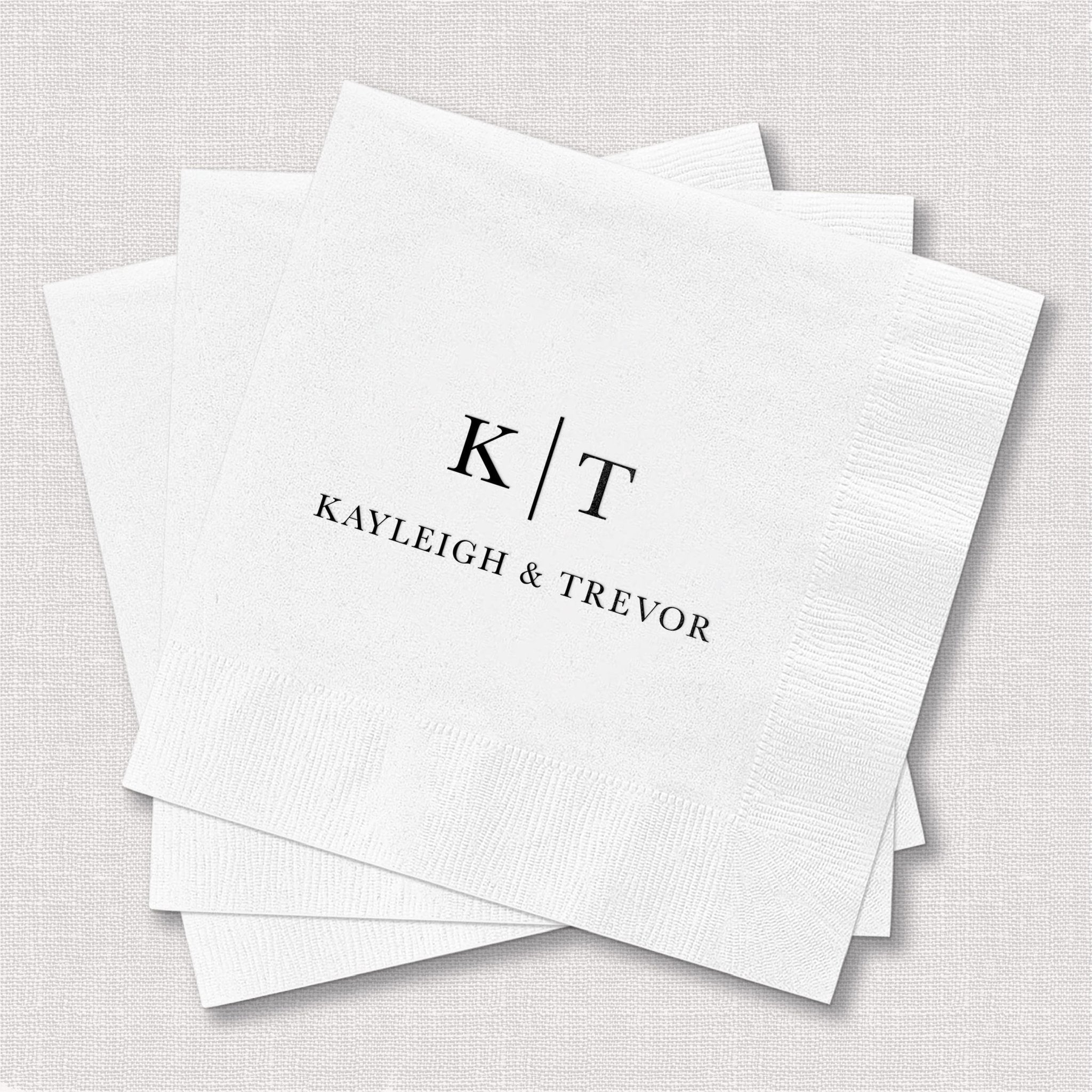 White foil-stamped napkins with initials K/T and names Kayleigh & Trevor in elegant black lettering