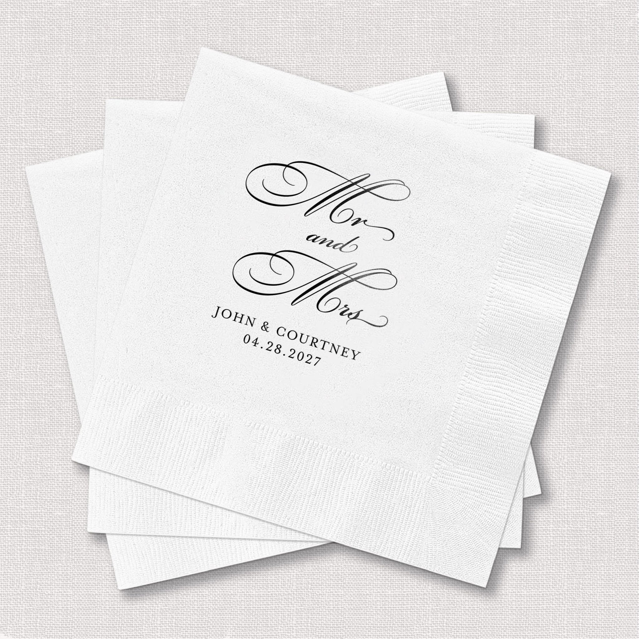 White napkins with "Mr and Mrs" script and couple names "John & Courtney" with wedding date foil stamped in black ink