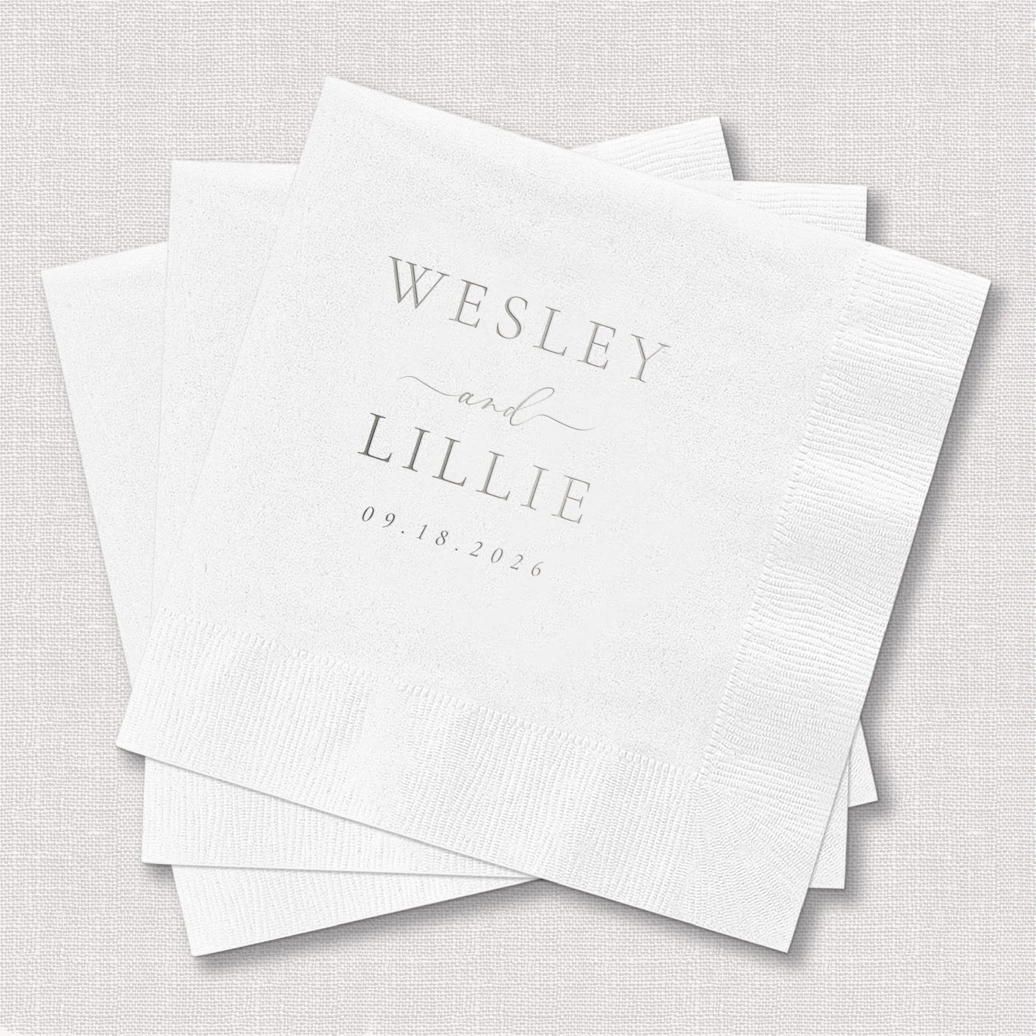 White foil-stamped napkins with Wesley and Lillie names and wedding date 09.14.2024 in gray lettering